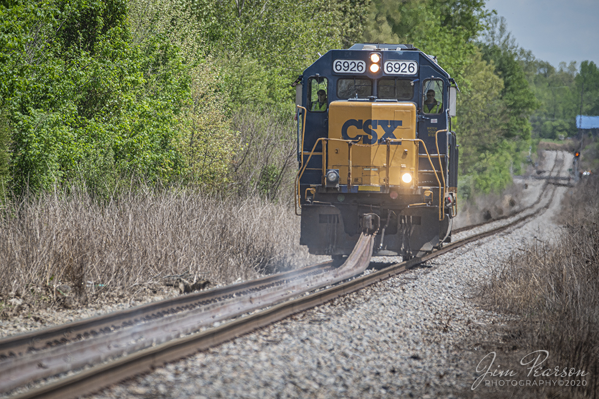 May 6, 2020 - Something you just don't see everyday is a CSX locomotive dragging 1/4 mile lengths of ribbon rail through the countryside, but that's what this picture shows! 

I got a call from good friend Keith Kittinger that CSX was moving rail from Providence to Madisonville, Ky on the Morganfield Branch by hooking it to CSXT 6926 by chain and dragging it between the rails with CSX crews flagging every crossing and others following behind the operation via high-rail vehicles. 

The rail was placed over a year ago with plans to replace the curves along the branch, but when Dotki mine closed down (only thing serviced between Madisonville and Providence) the work was never completed. 

Now, CSXT plans to start storing empty autoracks and intermodal flats along the line and so crews spent time moving the rail back toward the PeeVee Spur in Madisonville where it can be accessed when needed by the railroad.

Keep an eye here on my page as I'll be posting a video of the operation later on today!

Tech Info: Nikon D800, RAW, Sigma 150-600 @360mm, ISO 125, f/5.6, 1/800 sec.