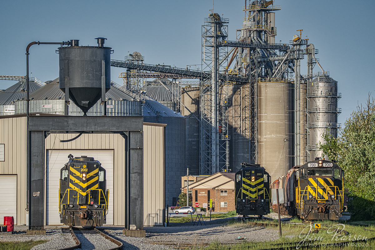 May 8, 2020 - The late afternoon sunlight rakes across the shop area at MG Rail (MGRI) as locomotives 2002, 2001 and 700 sit next to their engine house in Jeffersonville, Indiana. I had never heard of this shortline, but thankfully good friend Ryan Scott of SteelRails has and navigated us to MG's yard just before crews took two of the engines out of the yard with loaded hoppers for interchange work.

The shortline is owned and operated by Consolidated Grain and Barge (CG&B). It operates within the Clark Maritime Center, near Jeffersonville, Indiana. MGRI switches out several industries within the Maritime center and stages them at connections to CSX and Louisville & Indiana.

Tech Info: Nikon D800, RAW, Sigma 150-600 @210mm, f/1.7, 1/1600 sec at ISO 900.