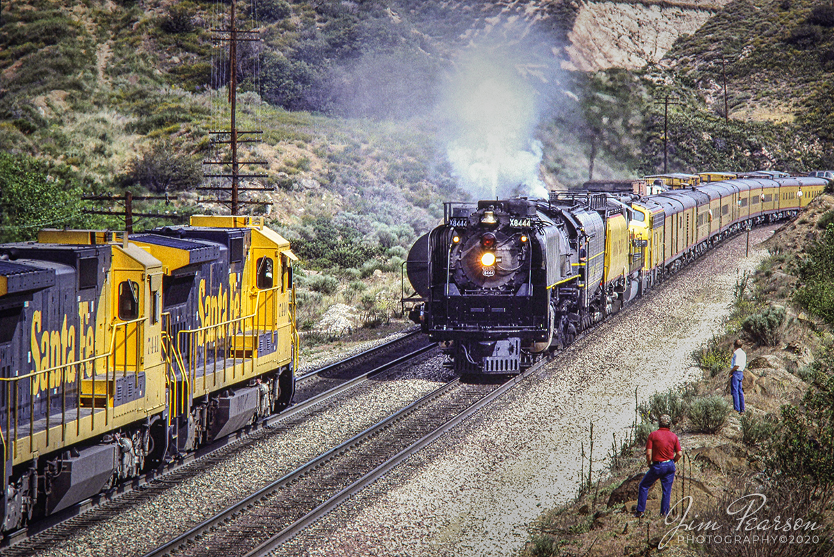 May 5, 1989 - The crew from a eastbound Santa Fe freight prepare to do a roll-by inspection on a passenger train being led by Union X8444 at Blue Cut in southern California's Cajon Pass on their way west to the 50th Anniversary Celebration of Los Angeles Union Station, with E-unit 951 trailing. This was the first Southern California appearance of a Union Pacific steam locomotive since 1956.