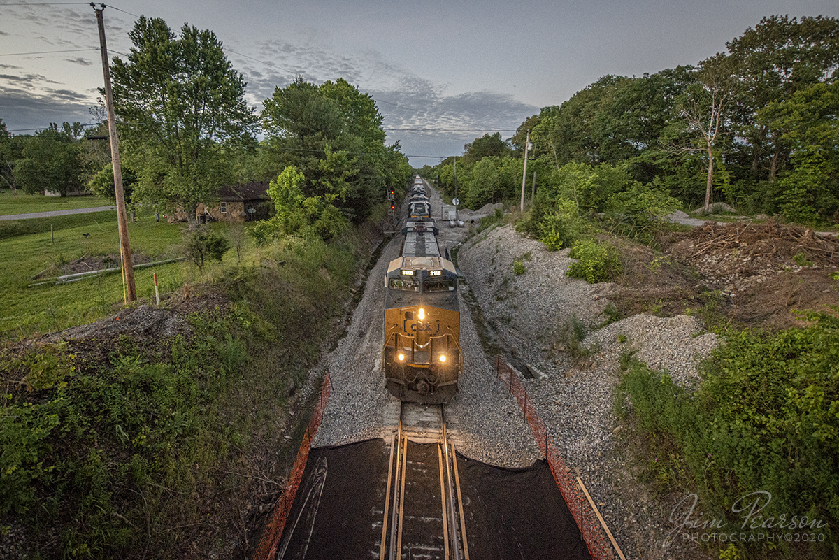 June 1, 2020 - Dusk settles across western Kentucky as CSX Q647 passes the signals at the south end of the siding at Kelly, KY as it rumbles south on the Henderson Subdivision at the old wooden overpass where preparations are underway its replacement with a new concrete bridge.

Tech Info: Nikon D800, RAW, Irex 11mm, f/4, 1/320, ISO 3200.