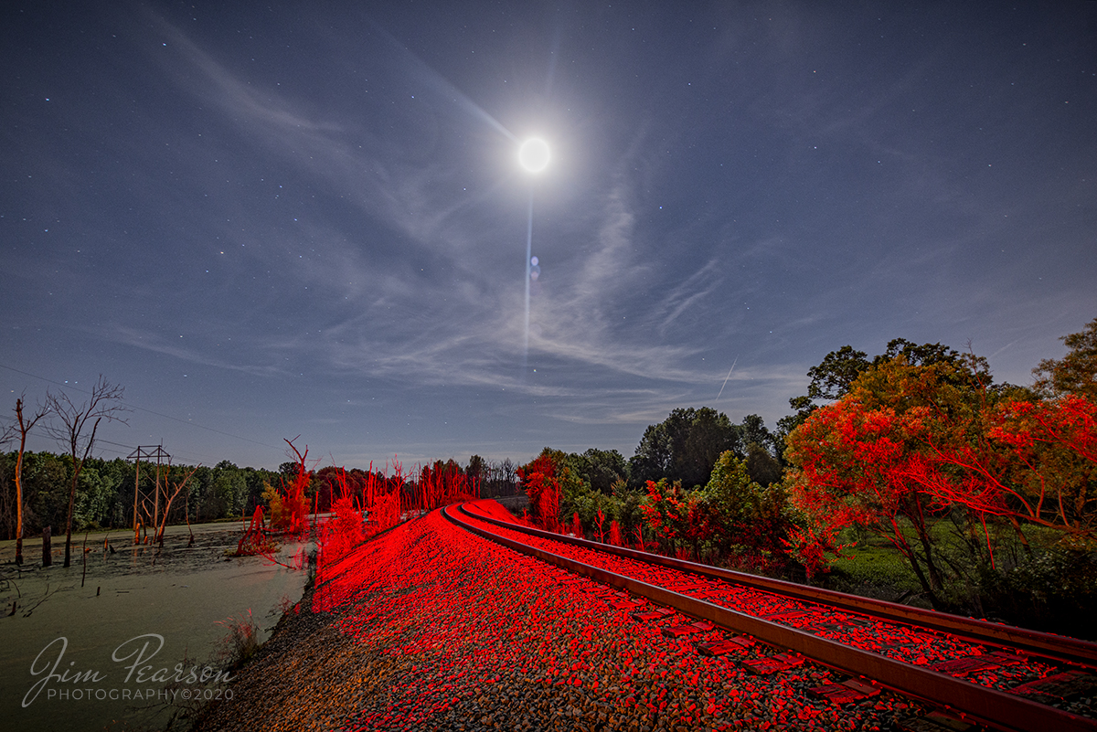 June 2, 2020 - The LED signal at the P&I Junction in Paducah, Ky illuminates the tracks approaching the switch, behind the camera, as a full moon begins to dip low in the sky over the scene. It's so bright it gives a Martian like view along the tracks as they disappear toward the bridge over the Paducah and Louisville Railway yard.

Tech Info: Nikon D800, RAW, Irex 11mm @ f/4, 30 seconds, ISO 400.