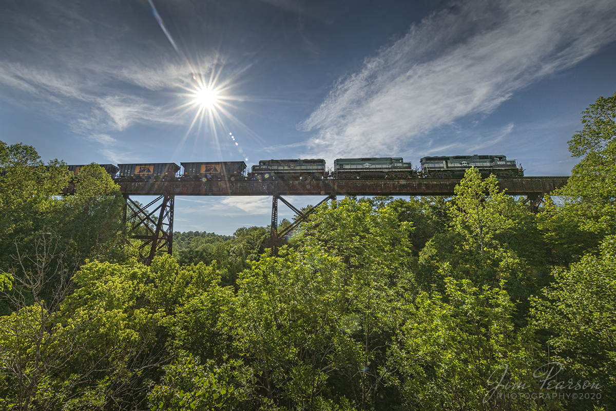 June 4, 2020 - Paducah and Louisville Railway (PAL) 3800, 2100 and 2121 lead Scotty's Rock train across the trestle at Big Clifty, Kentucky as they head north to their rock yard in Vine Grove, Ky with loaded rock cars. This is the highest trestle on the PAL railway.

Tech Info: Nikon D800, RAW, Irex 11mm, f/22, 1/800sec, 5 stops underexposed (exposed for the highlights so the sun wouldn't blow out completely), ISO 100. The smaller f/stop also gives the nice starburst on the sun!