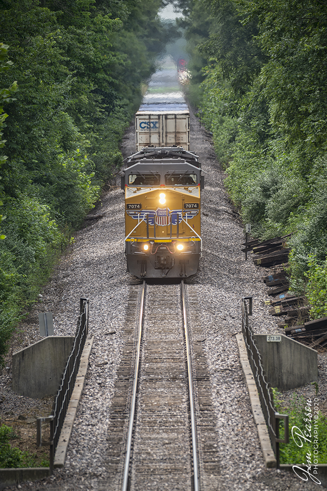 July 15, 2020 - Union Pacific 7074 leads UP IDLC as it approaches the Green Street overpass at Mount Vernon, Illinois as it makes its way north on the Mt. Vernon Subdivision. Fellow railfan, Cooper Smith and I spent the day railfanning in southern Illinois today and while we got a few nice shots and had a great time, the trains just didn't cooperate! 

We went from Kentucky to Bruceton, Illinois to catch UP and CN action through the diamond there, as well at Christopher and Du Quoin. However, after spending the whole day trackside we pretty much caught one train we each like at each location. Turns out after the one train on the busy UP line we caught at Mt. Vernon, that line was shut down the rest of the day till 9pm. We had no clue it was scheduled, but that's the way trains roll sometime! 

The other lines we railfanned were just having a very slow day, however we did catch at least something everywhere we stopped... eventually! The last stop of the day was at Anna, IL where we caught CN A431 being led by CN 2460 (a "Blue Devil" unit) as the very last light of a stormy evening stole the light from the day. 

I'll be posting a few others from the trip along with a couple videos for everyone's viewing pleasure! 

Tech Info: Full Frame Nikon D800, RAW, Sigma 150-600 @ 370mm, f/6, 1/640, ISO 320.