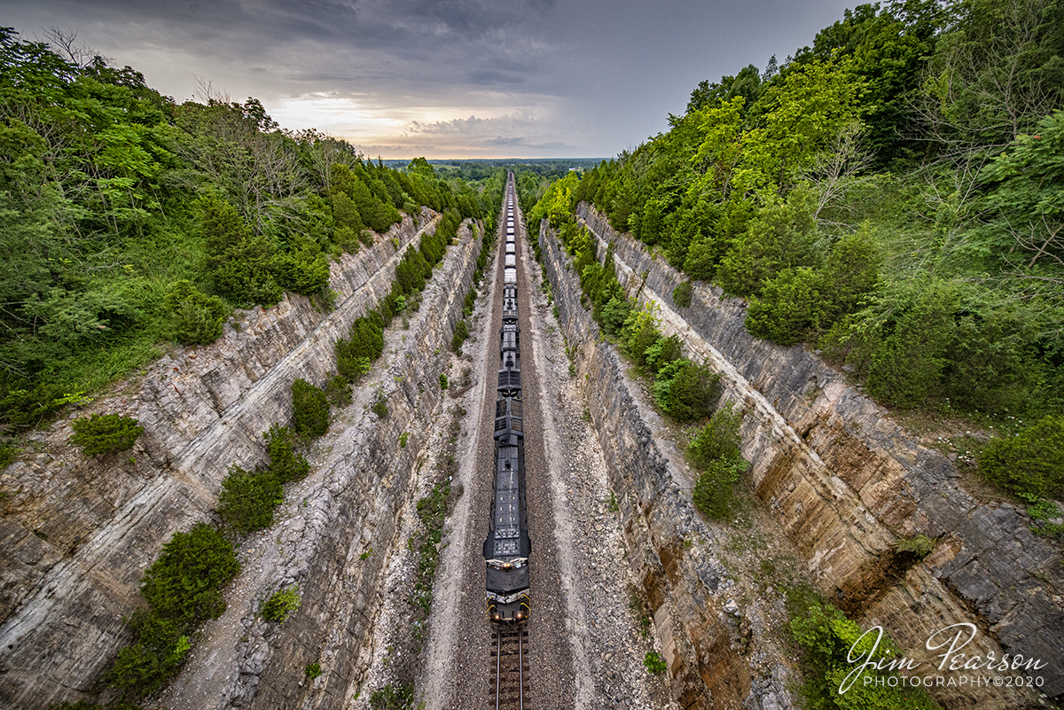 July 17, 2020 - Norfolk Southern 3645 leads a empty coal train as it passes through the cut at Tunnel Hill road overpass, just west of Ramsey, Indiana, with stormy skies looming to the east on the NS Southern-East District. This cut was constructed to bypass the original tunnel through this area and I'm told it can still be seen via Google Earth Maps of the area.

Tech Info: Full Frame Nikon D800, RAW, Irex 11mm, f/5.6, 1/400, ISO 1600.