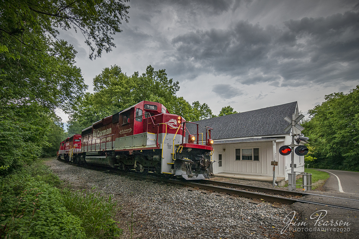 July 17, 2020 - RJ Corman ALCAN train southbound at Midway, Ky with RJC 7116 leading the way as it passes the old Spring Station, under stormy skies, between Jett and Midway, Ky on the Old Road Subdivision. The house at the crossing here used to be the Spring Station depot. The old freight house is to the left and hidden by the trees.

Tech Info: Full Frame Nikon D800, RAW, Irex 11mm, f/6.3, 1/500, ISO 1000.