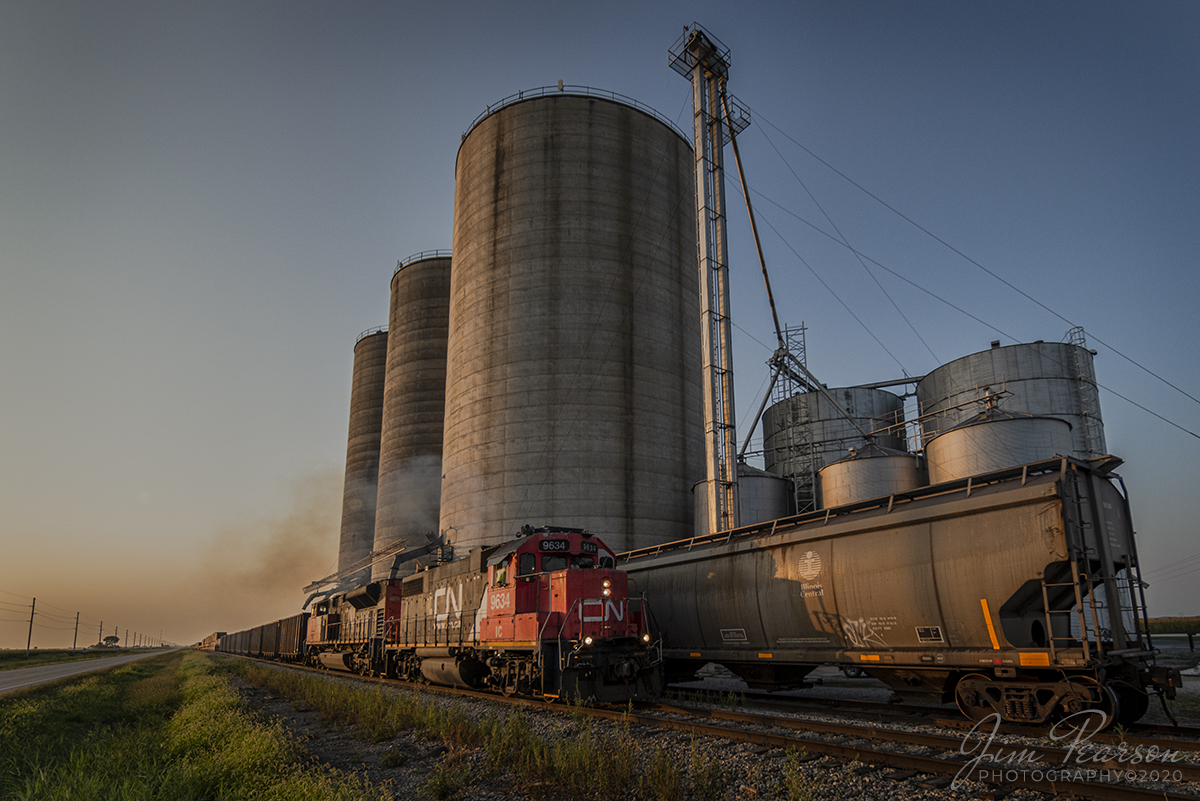 August 29, 2020 - The glint of the early morning light rakes across the landscape and illuminates the scene as Canadian National 9634 and 8879 lead CN L533-91 past Total Grain Marketing at Newton, Illinois. 

A fresh crew had just boarded the train and were taking the train to Effingham, IL on CN's Effingham Subdivision after picking up interchange work from from the Indiana Railroad in Palestine, Illinois.

Tech Info: Full Frame Nikon D800, RAW, Irex 11mm, f/5, 1/500, ISO 110.