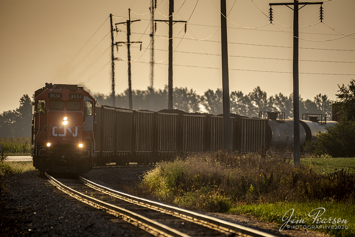 August 29, 2020 - The light from the early morning sunrise illuminates the scene as Canadian National 9634 and 8879 lead CN L533-91 around a curve as they head west into Teutopolis, Illinois on CN's Effingham Subdivision. 

Tech Info: Full Frame Nikon D800, RAW, Sigma 150-600 @ 460mm, f/6 1/1000, ISO 180.