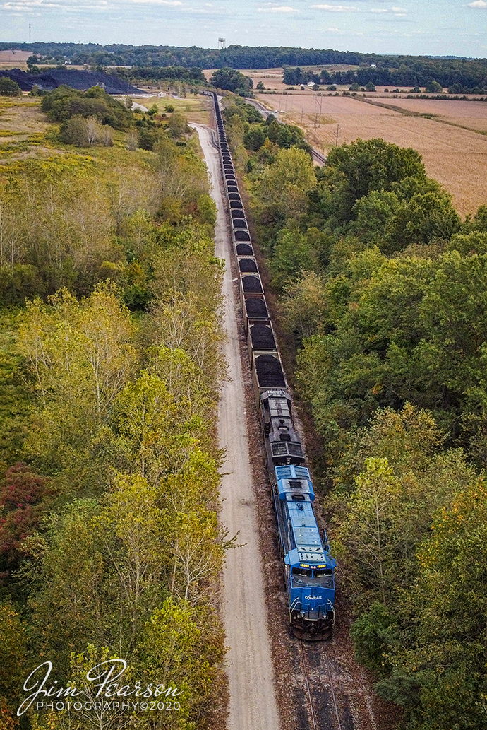 October 3, 2020 - Norfolk Southern Conrail Heritage Unit (8098) sits idling on the Francisco Mine lead at Francisco, Indiana, as it waits for a new crew to take the loaded coal train from the mine westbound on the NS Southern East/West District to Duke Energy's Gibson Plant near Mt. Carmel, Illinois.

Tech Info: DJI Mavic Mini Drone, JPG, 4.5mm (24mm equivalent lens) f/2.8, 1/400, ISO 100.