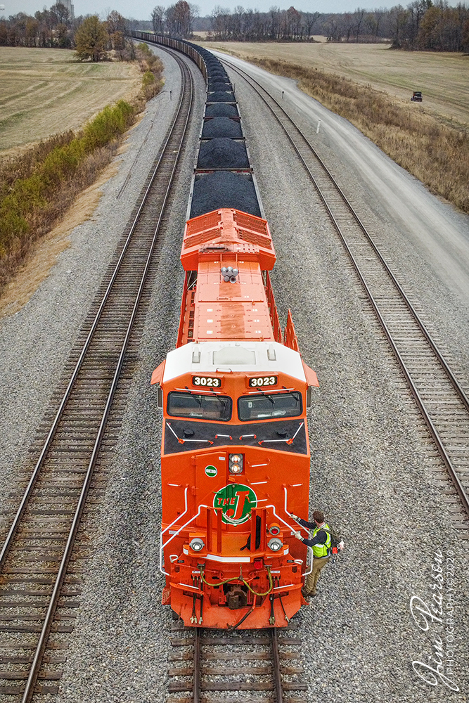 CN U700 Crew Change at Fulton, Ky

A  a crew member steps off Canadian National (CN) 3023, the new Elgin Joliet & Eastern Heritage locomotive, (EJ&E) leading loaded Pet coke train U700, during a crew change before heading on south on CNs Fulton subdivision at CP South Oaks, south of Fulton, Kentucky on November 21st, 2020.

CN 3023 of six locomotives representing the railways that have joined Canadian National Railway since their privatization, 25 years ago. The CN engines released in heritage paint so far are 3115 BC Rail; 8952 Grand Trunk Western; 8898 CN; 3008 Illinois Central; 3069 Wisconsin Central; and 3023 Elgin, Joliet & Eastern. 

Tech Info: DJI Mavic Mini Drone, JPG, 4.5mm (24mm equivalent lens) f/2.8, 1/100, ISO 100.