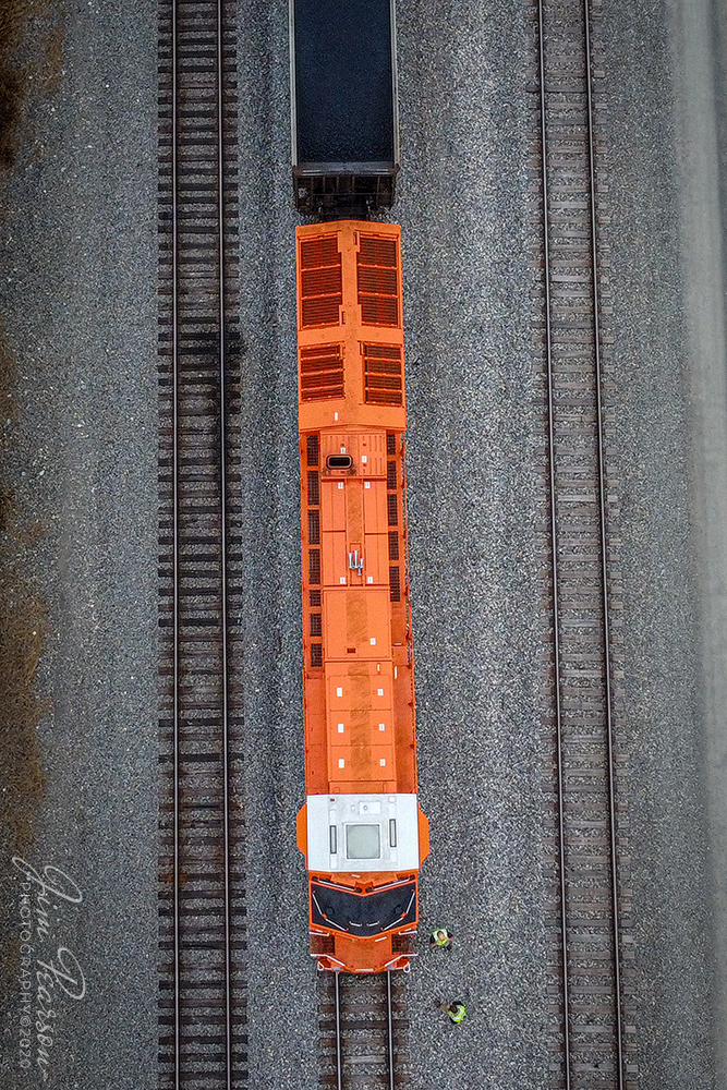 CN U700 Crew Change

A topside view of Canadian National 3023, the new Elgin Jolliet & Eastern Heritage unit, (EJ&E) leading loaded coke train U700 during a crew change (cropped photo and drone wasn't over engine or crew during flight) before heading on south on CNs Bluford subdivision at CP South Oaks at Fulton, Kentucky on November 21st, 2020.

According to a press release from CN: This is one of six locomotives representing the railways that have joined their team since their privatization, 25 years ago. Each one features the colors of the railway at the time it merged with CN as well as the logo specially created to commemorate the quarter century of our IPO. These acquisitions propelled our service farther than any other North American railway, similar to our IPO propelled CN to new heights. The engines release so far are 3115 BC Rail; 8952 Grand Trunk Western; 8898 CN; 3008 Illinois Central; 3069 Wisconsin Central; and 3023 Elgin, Joliet & Eastern.

Tech Info: DJI Mavic Mini Drone, JPG, 4.5mm (24mm equivalent lens) f/2.8, 1/100, ISO 100.