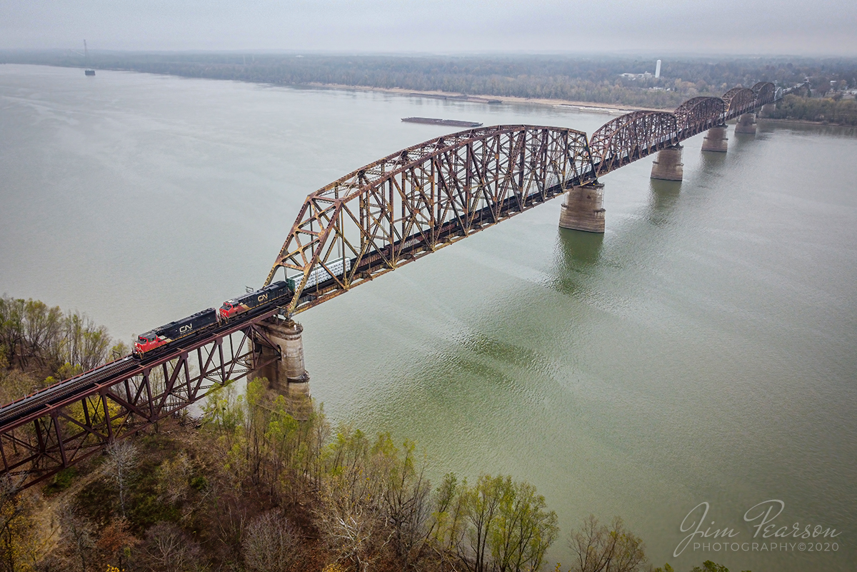 CN SB Mixed freight crossing the Ohio River 

Canadian National locomotives 5768 and 2864 head south across the Ohio River from Metropolis, Illinois with a mixed freight as they head south on the CN Bluford Subdivision, on November 21st, 2020.

According to the web: The Metropolis Bridge is a railroad bridge which spans the Ohio River at Metropolis, Illinois. Originally built for the Chicago, Burlington and Quincy Railroad, construction began in 1914 under the direction of engineer Ralph Modjeski. It has a single track jointly owned by Canadian National Railway, BNSF Railway and Paducah & Louisville Railway.

Tech Info: DJI Mavic Mini Drone, JPG, 4.5mm (24mm equivalent lens) f/2.8, 1/200, ISO 200.