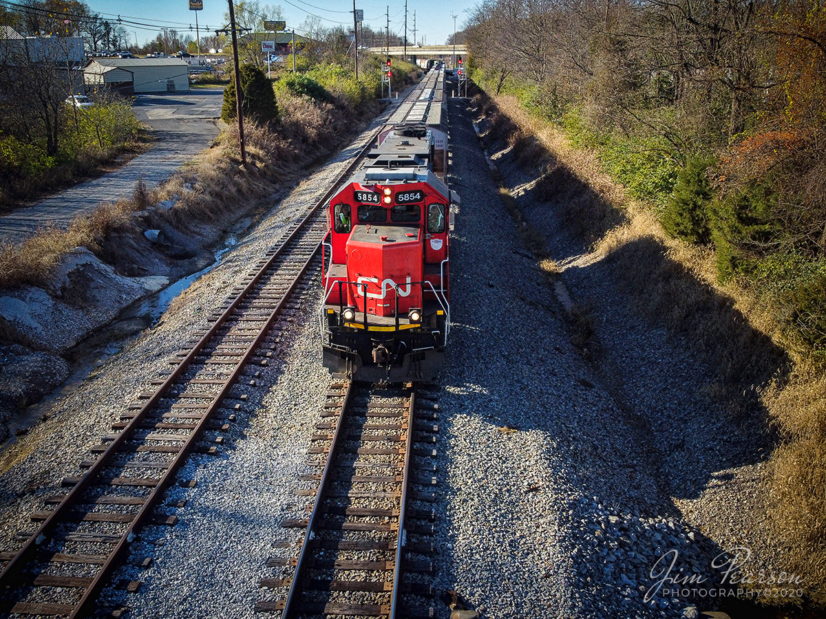 CN 5854 (GTW) leads the Fulton to Paducah Turn

With a seemingly ghost train running along side of it Canadian National 5854 (GTW) leads the Fulton to Paducah, Ky local into town to conduct it's interchange work with the Paducah and Louisville Railway as it approaches the Allen Lane crossing in Paducah. 

Tech Info: DJI Mavic Mini Drone, JPG, 4.5mm (24mm equivalent lens) f/2.8, 1/800, ISO 100.