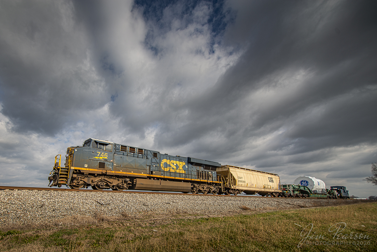 CSX W991-29 Northbound high and wide load at Guthrie, Ky

CSX W991-29 heads north on the Henderson Subdivision as it approaches milepost 214, just south of Guthrie, Kentucky on December 5th, 2020 with a High and Wide load for General Electric, running at a steady 25mph.

The GE high and wide load is carried on GECX 021155 a Heavy load, 16-axle, depressed center flat car, which is owned by General Electrical Gas Turbine division. The car is 147 feet 10 inches long and the load deck length is 38 feet according to what I find on the web. It Was built in May of 1995 and is used to transport heavy gas turbines built by General Electric. A Kasgro Rail Corporation (KRL) caboose 072 brings up the rear with a full crew. The caboose and engine crews kept a close eye on clearances as they made their way north! 

Tech Info: Nikon D800, RAW, Irex 11mm, f/4, 1/1000, ISO 100.