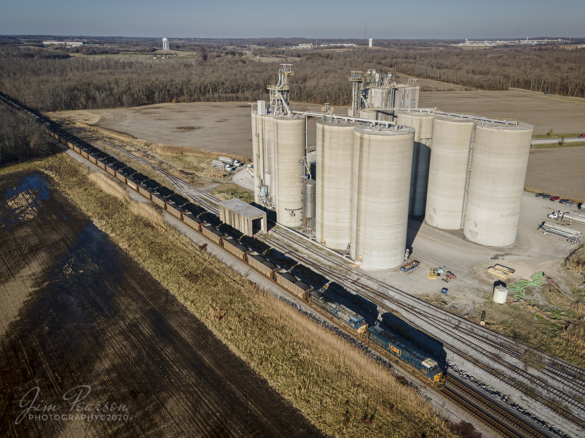 Southbound shadow train at Sebree, Kentucky

CSXT 3113 & 214 lead loaded coal train N040-09 as its shadow chases along on the track next to it as it passes the Planters Bank Grain silos headed south on the Henderson Subdivision at Sebree, Kentucky on December 9th, 2020. 

Tech Info: DJI Mavic Air 2 Drone, JPG, 4.5mm (24mm equivalent lens) f/2.8, 1/640, ISO 100.