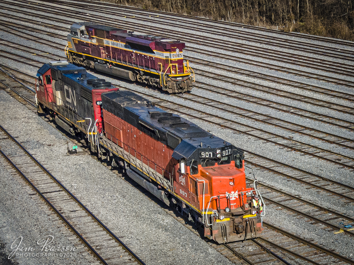 CN FUPD Local working the PAL yard at Paducah, Ky.

Bessemer & Lake Erie Railroad 907 heads up the CN Fulton to Paducah local as it passes Canadian Pacific 7015 as it moves north through the Paducah and Louisville Railway yard at Paducah, Kentucky. It was on its way to pickup its train for the return trip to Fulton during its interchange work on the first day of winter, December 21, 2020.

Not sure what the Canadian Pacific 7015 Maroon and Gray Heritage Unit was doing at Paducah, but it made for a nice shot with the CN local.

According to Wikipedia: "The Bessemer and Lake Erie Railroad (reporting mark BLE) is a class II railroad that operates in northwestern Pennsylvania and northeastern Ohio.

The railroad's main route runs from the Lake Erie port of Conneaut, Ohio to the Pittsburgh suburb of Penn Hills, Pennsylvania, a distance of 139 miles (224 km). The original rail ancestor of the B&LE, the Shenango and Allegheny Railroad, began operation in October 1869.

Rail operations were maintained continuously by various corporate descendants on the growing system that ultimately became the B&LE in 1900. In 2004 B&LE came under the ownership of the Canadian National Railway (CN) as part of CN's larger purchase of holding company Great Lakes Transportation. B&LE is operated by CN as their Bessemer Subdivision. 

As a subsidiary of CN, B&LE has been largely unchanged (though repainting of B&LE locomotives into CN paint with "BLE" sub-lettering began in April 2015) and still does business as B&LE. B&LE locomotives, especially the former Southern Pacific SD40T-3 "Tunnel Motors", have been scattered across the CN system; many are being used in the line that feeds most of B&LE's traffic, the former Duluth, Missabe, and Iron Range lines in Minnesota. The iron ore that originates on these lines is transloaded to ships at Two Harbors, Minnesota, then sent by ship to Conneaut, Ohio, where it is again transloaded to B&LE trains. 

It is then taken down to steel mills in the Pittsburgh region, mainly to the blast furnaces at US Steel's Edgar Thomson Plant in Braddock, Pennsylvania, part of the Mon Valley Works."

Tech Info: DJI Mavic Air 2 Drone, JPG, 4.5mm (24mm equivalent lens) f/2.8, 1/640, ISO 100.