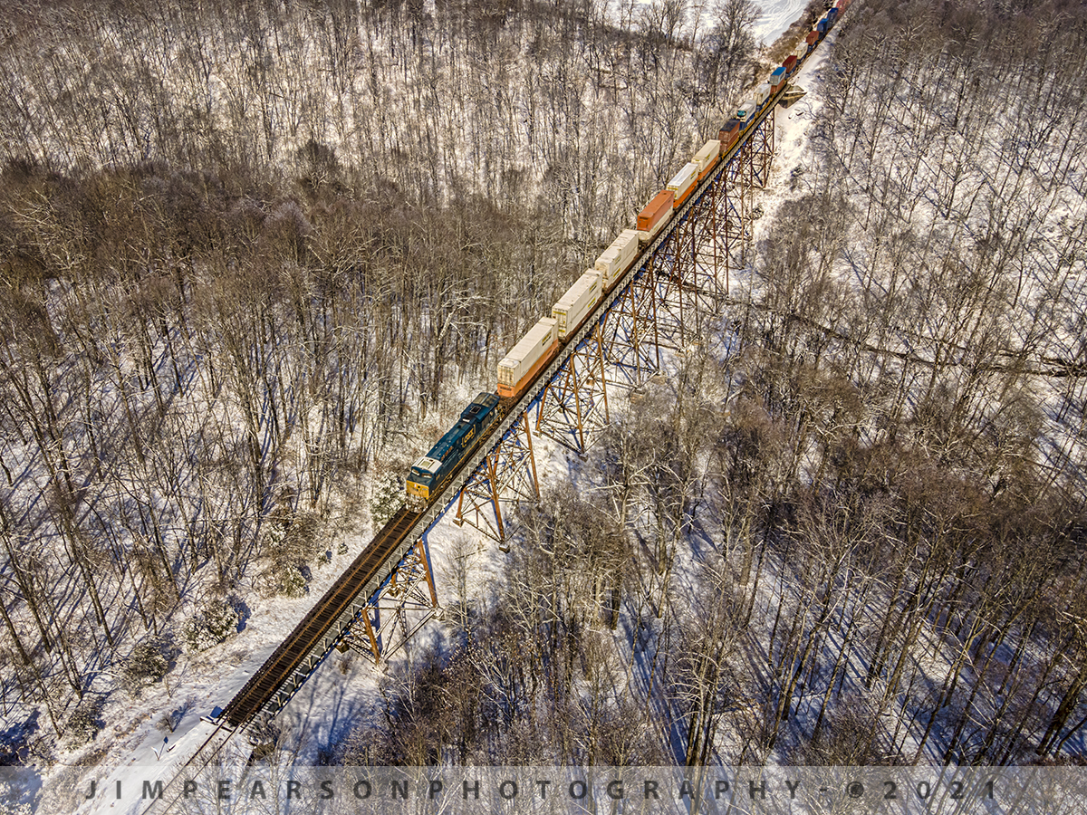 Southbound Intermodal at Gum Lick Trestle

CSX Q029 heads south, across Gum Lick, the highest trestle on the Henderson Subdivision, in the frigid cold, on February 19th, 2021 as the morning light rakes across the landscape sending shadows across the forest floor. 

The "Gum Lick" name comes from the fact that the valley here is named Gum Lick Hollow and it sits between Crofton and Kelly Kentucky where it crosses over the West Fork of Pond River. 

It's located between J. Knight road crossing and the Cavanaugh Lane overpass.

Tech Info: DJI Mavic Air 2 Drone, RAW, 4.5mm (24mm equivalent lens) f/2.8, 1/1000, ISO 100.