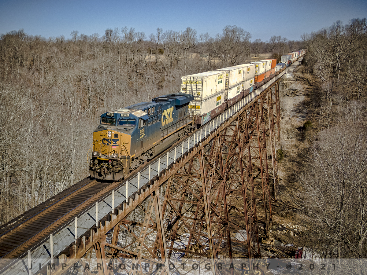 CSX hot intermodal rolls south across Gum Lick Trestle

This picture really shows the difference a day or so can make! Two days before there was about 4-6 inches of at this location and the temperature was 17 degrees and on this day if was 65 degrees!!! Makes for very different photos, but both situations make for great photo possibilities! 

Here we have hot intermodal CSX Q029-23 with CSXT 928 leading on February 23rd, 2021 as it makes its way across the Gum Lick Trestle between Crofton and Kelly, Kentucky on the Henderson Subdivision on a beautiful winter (kinda) day.

Tech Info: DJI Mavic Air 2 Drone, RAW, 4.5mm (24mm equivalent lens) f/2.8, 1/800, ISO 100.