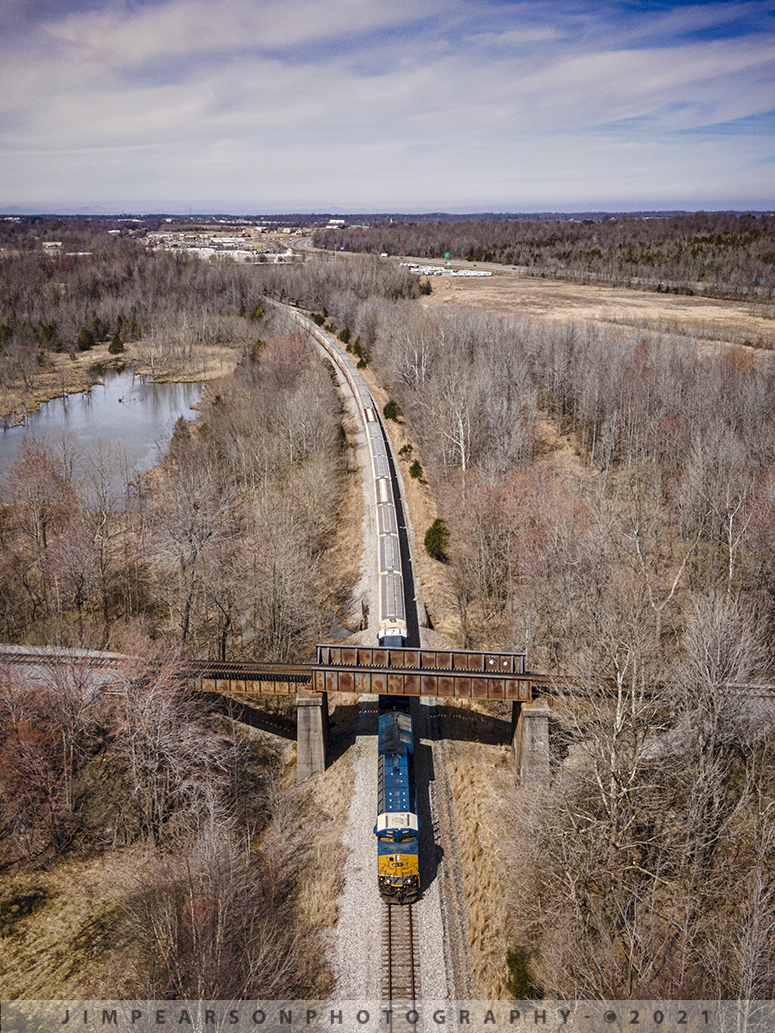 CSX loaded grain train G108 southbound at Madisonville, Ky

This is a spot I've never been able to photograph a train at before, as it's pretty much inaccessible unless you trespass and walk in along the right-of-way, which I don't do. The drone has opened a lot of new spots to photograph such as this location south of East Diamond on the CSX Henderson Subdivision, where the Paducah and Louisville Railway (PAL) crosses over the CSX Earlington Cutoff at Madisonville, Ky.

On March 16th, 2021 I flew my DJI Air 2 to this spot to capture this photo of CSXT 3261 leading an exceptionally long loaded grain train, G108, as it passed under the PAL on its way south on what's called the Earlington Cutoff on the Henderson Subdivision. 

This track allows the CSX dispatcher to run trains around the towns of Madisonville and Earlington, Ky, freeing up the mainline track through both these towns, to run trains around and past each other. 

I've never heard this specific spot called anything special by the crews, unlike the PAL crossover at Monarch on the CSX main at Madisonville.

For those who are wondering, I waited for the train to get to my spot in this photo and then moved the drone away from the track before the train passed under my drone, keeping within the FAA guidelines. The photo was obviously cropped to a vertical from a much wider shot at 48mp. This is how I obtain all my verticals when using the drone.

Tech Info: DJI Mavic Air 2 Drone, RAW, 4.5mm (24mm equivalent lens) f/2.8, 1/1000, ISO 100.