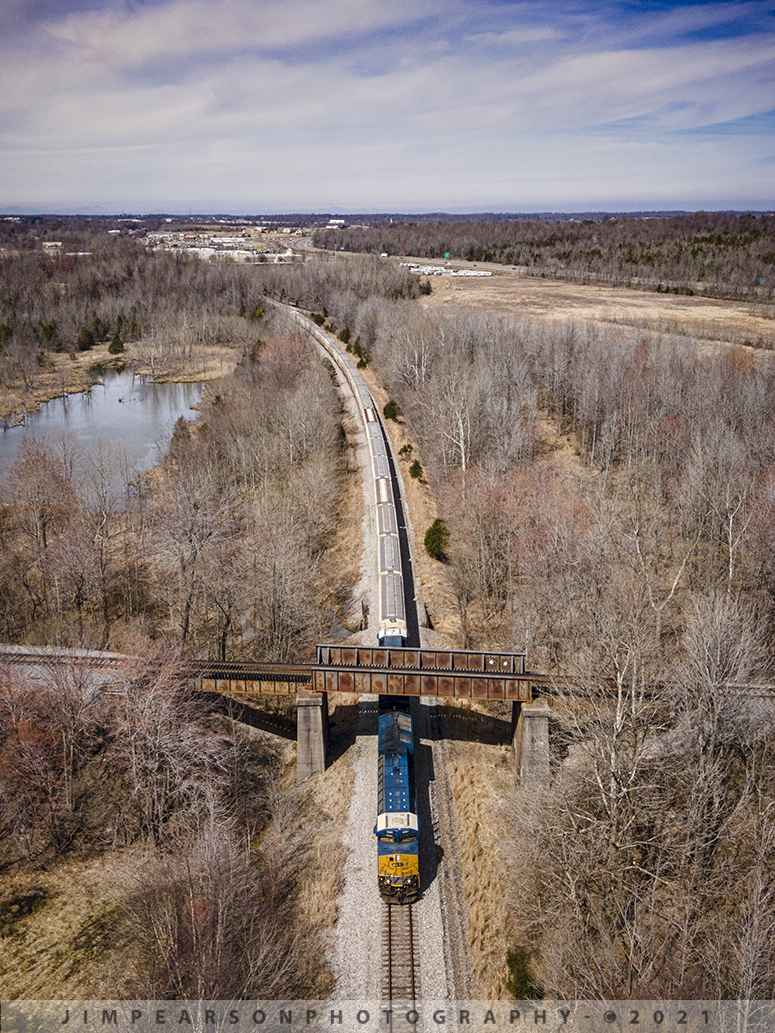 CSX loaded grain train G108 southbound at Madisonville, Ky

This is a spot I've never been able to photograph a train at before, as it's pretty much inaccessible unless you trespass and walk in along the right-of-way, which I don't do. The drone has opened a lot of new spots to photograph such as this location south of East Diamond on the CSX Henderson Subdivision, where the Paducah and Louisville Railway (PAL) crosses over the CSX Earlington Cutoff at Madisonville, Ky.

On March 16th, 2021 I flew my DJI Air 2 to this spot to capture this photo of CSXT 3261 leading an exceptionally long loaded grain train, G108, as it passed under the PAL on its way south on what's called the Earlington Cutoff on the Henderson Subdivision. 

This track allows the CSX dispatcher to run trains around the towns of Madisonville and Earlington, Ky, freeing up the mainline track through both these towns, to run trains around and past each other. 

I've never heard this specific spot called anything special by the crews, unlike the PAL crossover at Monarch on the CSX main at Madisonville.

For those who are wondering, I waited for the train to get to my spot in this photo and then moved the drone away from the track before the train passed under my drone, keeping within the FAA guidelines. The photo was obviously cropped to a vertical from a much wider shot at 48mp. This is how I obtain all my verticals when using the drone.

Tech Info: DJI Mavic Air 2 Drone, RAW, 4.5mm (24mm equivalent lens) f/2.8, 1/1000, ISO 100.