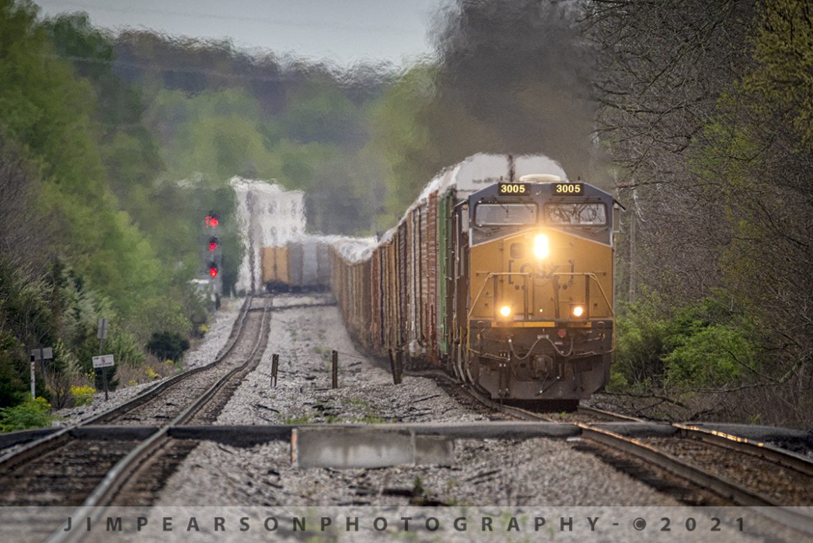 Northbound Autorack on the CSX Mainline at Elizabethtown, KY

I totally enjoy exploring new territory when it comes to railfanning and such was the case here on the CSX Mainline Subdivision, with fellow railfan and navigator, Cooper Smith on April 14th, 2021.

Here we find CSXT 3005 leading autorack Q202 northbound through Elizabethtown, Ky on the CSX Mainline Subdivision. This sub runs between Nashville, TN and Louisville, Ky and while I have railfanned it before, it has been several years and Ive really only explored it around the Bowling Green, Ky area.

Cooper and I actually tried to catch this train at a crossing at the other end, but we saw where another autorack was in the siding and thought wed go find the next crossing to get a shot of this passing the other. However, if you notice way down the track to the left where the other train sets, it has no power, plus its further back than we thought itd be. Even with my long lens if it had power on it I dont think it would have mattered. As it was this was shot at 850mm at over ¼ mile away.

Tech Info: Nikon D800, RAW, Sigma 150-600mm with a 1.4 teleconverter @ 850mm, f/9, 1/640, ISO 1100.