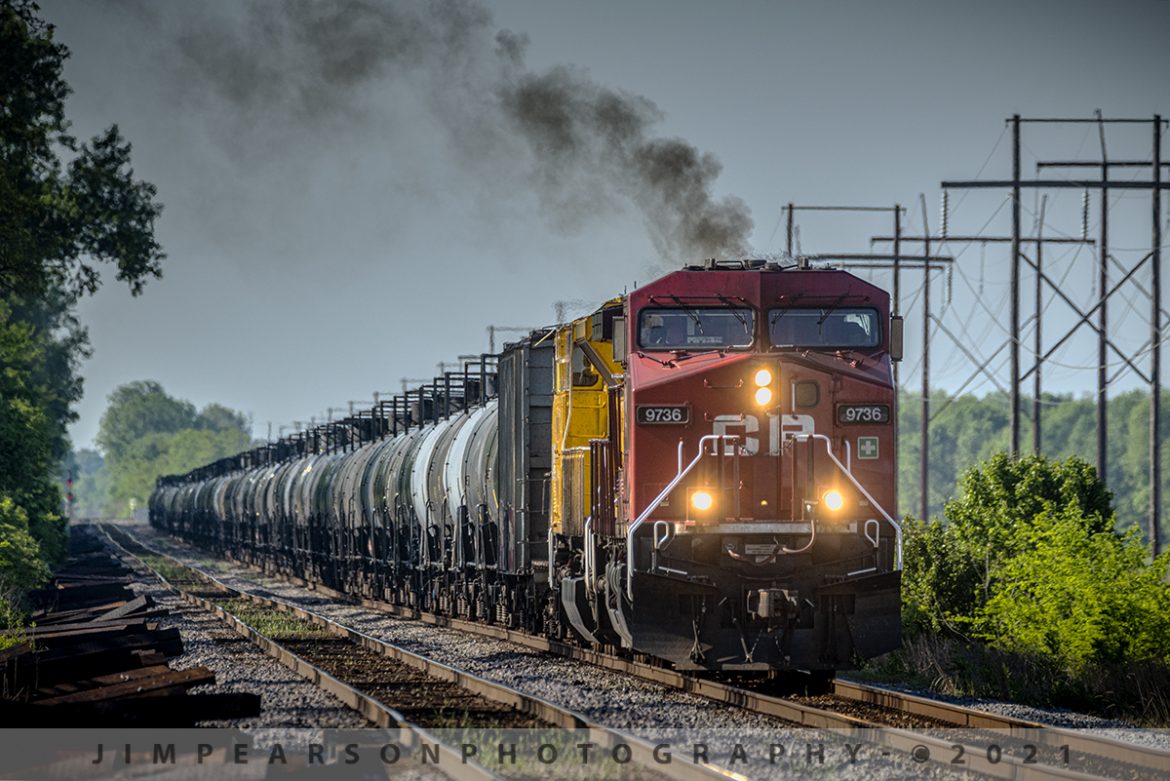 CSX K442 pulls north from the siding at Rankin, Kentucky

CSX K442 starts to pull away from the north end of the siding at Rankin, Kentucky as it makes its way south on the Henderson Subdivision on May 7th, 2021 with Canadian Pacific 9736 leading an empty ethanol train with Progress Rail 7205 (SD70ACe-T4), trailing behind.

According to Wikipedia: Progress Rail Locomotives, doing business as Electro-Motive Diesel is an American manufacturer of diesel-electric locomotives, locomotive products, and diesel engines for the rail industry.

The company is owned by Caterpillar through its subsidiary Progress Rail. Electro-Motive Diesel traces its roots to the Electro-Motive Engineering Corporation, a designer and marketer of gasoline-electric self-propelled rail cars founded in 1922 and later renamed Electro-Motive Company.

In 1930, General Motors purchased Electro-Motive Company and the Winton Engine Co. and in 1941 expanded EMDs realm to locomotive engine manufacturing as Electro-Motive Division.

In 2005, GM sold EMD to Greenbriar Equity Group and Berkshire Partners, which formed Electro-Motive Diesel to facilitate the purchase. In 2010, Progress Rail completed the purchase of Electro-Motive Diesel from Greenbriar, Berkshire, and others.

Tech Info: Nikon D800, RAW, Sigma 150-600mm @ 600mm, f/8.5, 1/1000, ISO 720.