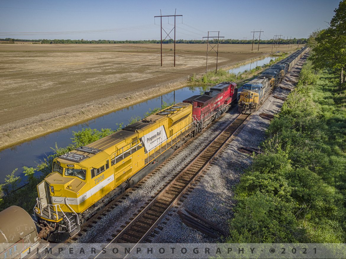 A foreign power meet at the north end of Rankin, Ky

CSX Q647 rolls past the head end of CSX K442 at the north end of the siding at Rankin, Kentucky as it makes its way south on the Henderson Subdivision on May 7th, 2021 where it prepares to pass Progress Rail 7205 (SD70ACe-T4), trailing behind Canadian Pacific 9736.

According to Wikipedia:  Progress Rail Locomotives, doing business as Electro-Motive Diesel is an American manufacturer of diesel-electric locomotives, locomotive products, and diesel engines for the rail industry. 

The company is owned by Caterpillar through its subsidiary Progress Rail. Electro-Motive Diesel traces its roots to the Electro-Motive Engineering Corporation, a designer and marketer of gasoline-electric self-propelled rail cars founded in 1922 and later renamed Electro-Motive Company. 

In 1930, General Motors purchased Electro-Motive Company and the Winton Engine Co. and in 1941 expanded EMC's realm to locomotive engine manufacturing as Electro-Motive Division. 

In 2005, GM sold EMD to Greenbriar Equity Group and Berkshire Partners, which formed Electro-Motive Diesel to facilitate the purchase. In 2010, Progress Rail completed the purchase of Electro-Motive Diesel from Greenbriar, Berkshire, and others.

Tech Info: DJI Mavic Air 2 Drone, RAW, 4.5mm (24mm equivalent lens) f/2.8, 1/500, ISO 100.