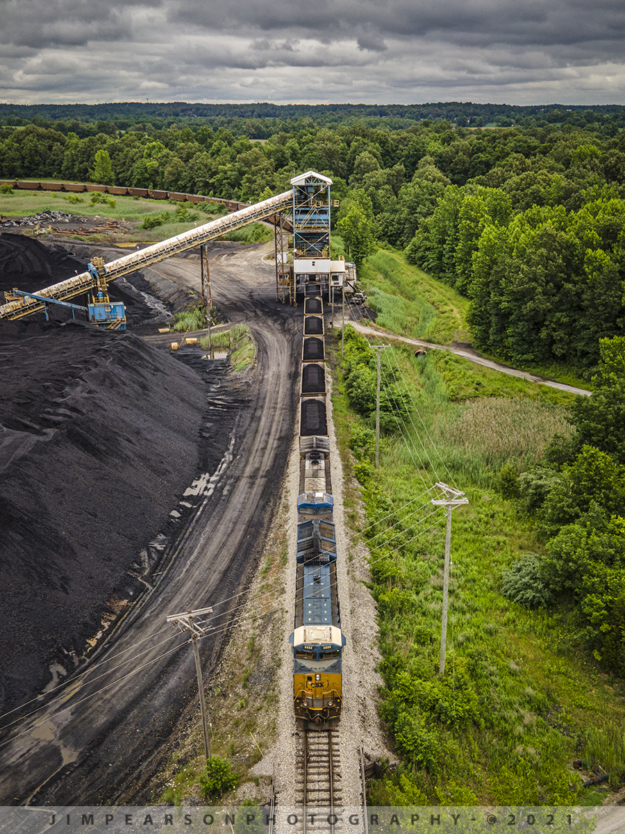 CSX J801-06 loads at Warrior Coal Mine Loop, Nebo, Kentucky

CSXT 3322 and 322 lead as CSX J801-06 creeps along as it starts to load at the Warrior Coal mine loop, just outside of Nebo, Kentucky on June 7th, 2021 under stormy skies. This train comes out of CSX Atkinson Yard in Madisonville, Ky where it will return to after loading and be combined with another loaded coal train of similar length before heading south on the Henderson Subdivision.

Tech Info: DJI Mavic Air 2 Drone, RAW, 4.5mm (24mm equivalent lens) f/2.8, 1/320, ISO 100.