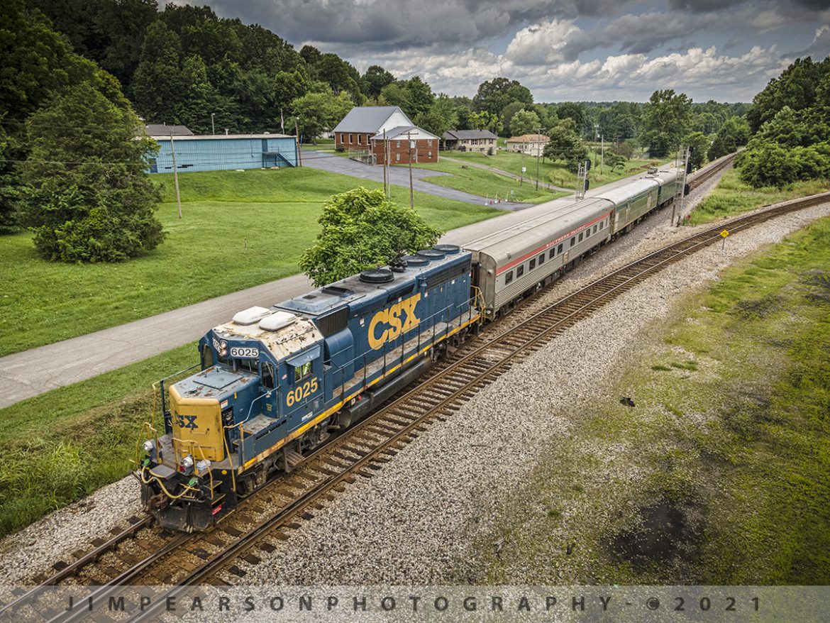 CSX Track Inspection trainset W001 at Mortons Junction, Mortons Gap, KY

CSXT 6025 leads CSX W001 inspection train as it passes through Mortons Junction at Mortons Gap, Kentucky with Southern Pacific Birch Grove, CSX Florence and TGC2 Geometry Car trailing, as they make their way south on the Henderson Subdivision on July 13, 2021.

Research from a friend reveals: Built by The Budd Company in 1950 as 6 double bedroom, 10 roomette sleeping car 9020 for service on the Southern Pacific's Los Angeles-New Orleans "Sunset Limited." The car was acquired by Amtrak in 1971 and renumbered 2696. Converted to Heritage 10-6 sleeper with handicapped roomette in 1980 and renumbered to 2451 and named Birch Grove. 

The Car was retired in 1995 and sold to Cincinnati Railway Company. It was upgraded 2002-03 and had a complete interior upgrade in 2005. As of 2014 it was owned by the Cincinnati Railway Company.

CSX purchased the Birch Grove car from the Cincinnati Railway in September of 2020 and from what I find online they plan to use it as part of its executive fleet. They also bought the dome car Moonlight Dome from them for the same reason.
According to Wikipedia: A track geometry car (also known as a track recording car) is an automated track inspection vehicle on a rail transport system used to test several parameters of the track geometry without obstructing normal railroad operations. Some of the parameters generally measured include position, curvature, alignment of the track, smoothness, and the cross level of the two rails. The cars use a variety of sensors, measuring systems, and data management systems to create a profile of the track being inspected.

One of the earliest track geometry cars was Car T2 used by the U.S. Department of Transportation's Project HISTEP (High-Speed Train Evaluation Program). It was built by the Budd Company for Project HISTEP to evaluate track conditions between Trenton and New Brunswick, NJ, where the DOT had established a section of track for testing high-speed trains, and accordingly, the T2 ran at 150 miles per hour or faster.

Tech Info: DJI Mavic Air 2 Drone, RAW, 4.5mm (24mm equivalent lens) f/2.8, 1/400, ISO 100.