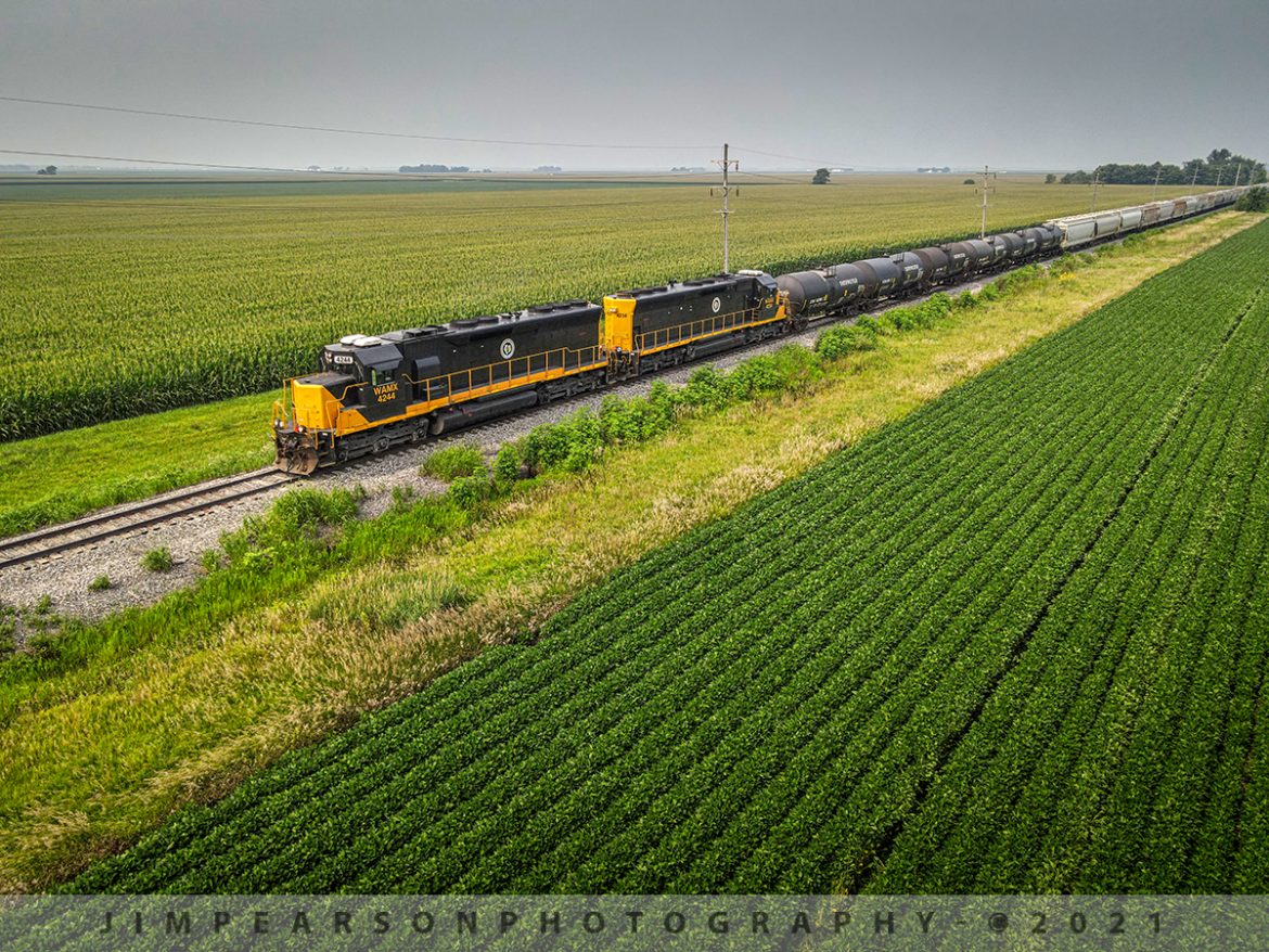 Lines heading east on the Decatur & Eastern Railroad at Murdock, Illinois

Decatur & Eastern Illinois Railroad units WAMX 4244 and 4234 lead local Y101 on its way to Terre Haute, Indiana as it passes through the farming countryside as it heads east at Murdock, Illinois on July 20th, 2021.

According to Wikipedia: "The Decatur & Eastern Illinois Railroad (reporting mark DREI) is an American regional railroad that is a subsidiary of Watco operating in eastern Illinois and western Indiana.

In January 2018, CSX Transportation announced that it was seeking offers to buy the Decatur Subdivision and the Danville Secondary Subdivision as part of a system-wide sale of low-traffic routes, and in July, Watco, via the DREI, was identified as the winning bidder. Following regulatory approval from the Surface Transportation Board, The DREI began operations on September 9, 2018

The DREI operates two intersecting routes totaling 126.7 miles (203.9 km)the former Decatur Subdivision between Montezuma, Indiana and Decatur, Illinois, and the former Danville Subdivision between Terre Haute, Indiana and Olivet, Illinois. It interchanges traffic with CSX, the Eastern Illinois Railroad, the Norfolk Southern Railway, the Canadian National Railway and the Union Pacific Railroad. The railroad is headquartered in Decatur, Illinois."

Tech Info: DJI Mavic Air 2 Drone, RAW, 4.5mm (24mm equivalent lens) f/2.8, 1/640, ISO 100.