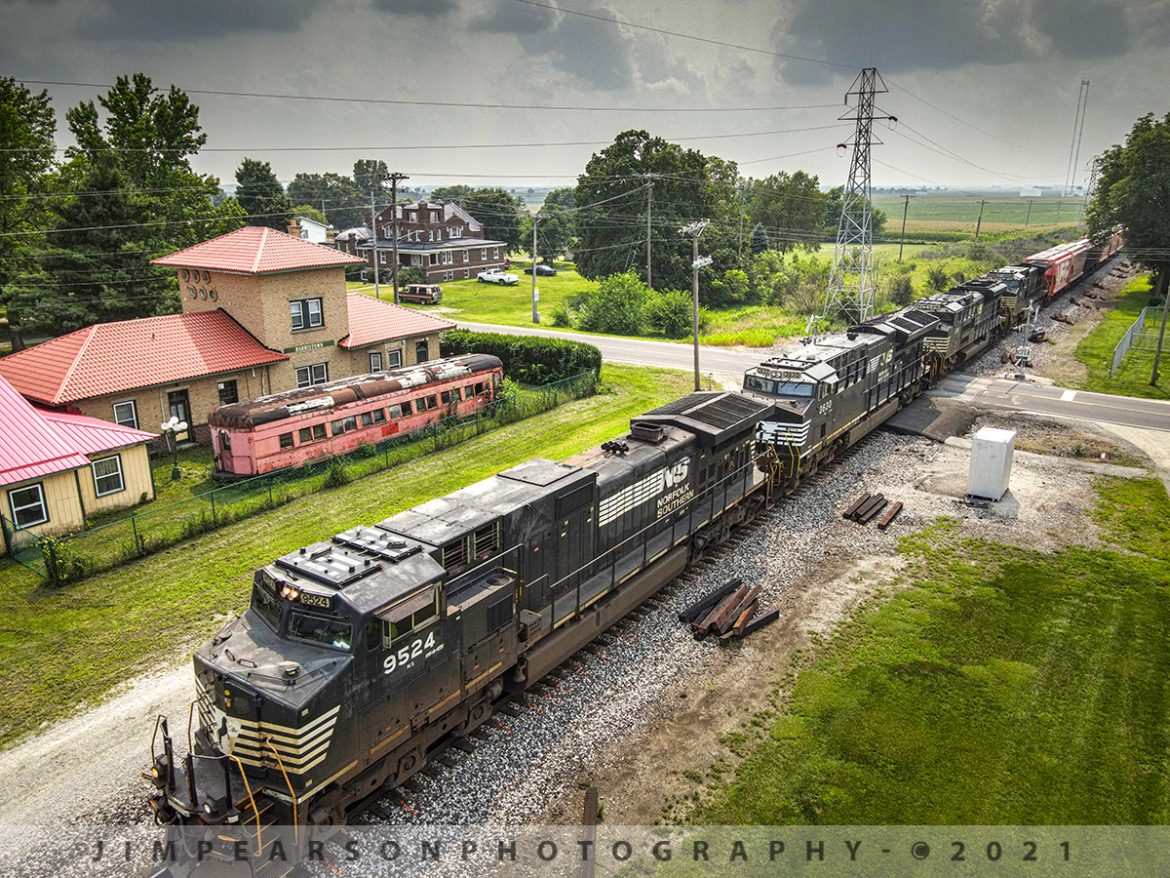 NS 148 passes the past, at Harristown, Illinois

Norfolk Southern train 148 heads east past Illinois Terminal Railroad sleeper car 535 as it sits next to the Illinois Terminal Company Train Station in Harristown, Illinois on the NS Southern West District on July 21st. 2021.

A web search shows the car was built by the St. Louis Car Company in 1911 as an Interurban trailer car and was renovated into a sleeper in 1930 where it operated as a sleeper until 1941. The station was built in 1910 and currently houses Sanders Harristown Depot Antiques.

According to Wikipedia: The Illinois Terminal Railroad Company (reporting marks "ITC"), known as the Illinois Traction System until 1937, was a heavy duty interurban electric railroad with extensive passenger and freight business in central and southern Illinois from 1896 to 1956. 

When Depression era Illinois Traction was in financial distress and had to reorganize, the Illinois Terminal name was adopted to reflect the line's primary money-making role as a freight interchange link to major steam railroads at its terminal ends, Peoria, Danville, and St. Louis. Interurban passenger service slowly was reduced, ending in 1956. 

Freight operation continued but was hobbled by tight street running in some towns requiring very sharp radius turns. In 1956, ITC was absorbed by a consortium of connecting railroads.

Tech Info: DJI Mavic Air 2 Drone, RAW, 4.5mm (24mm equivalent lens) f/2.8, 1/800, ISO 110.