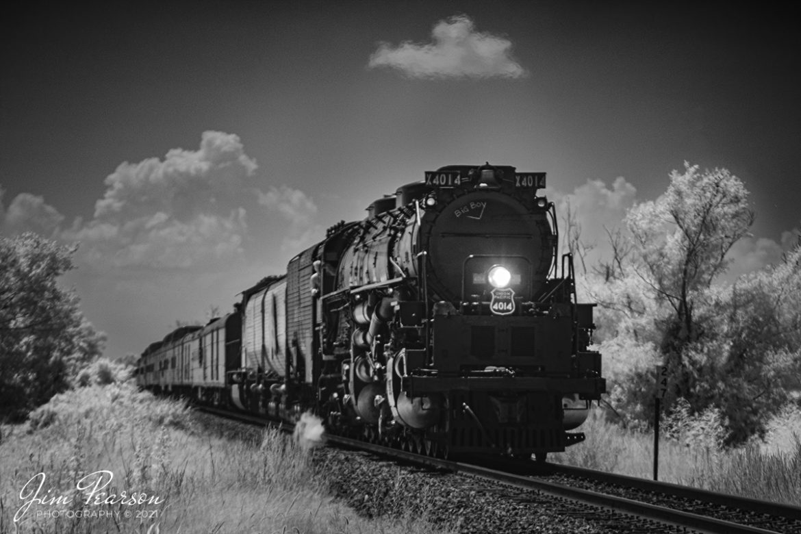 Engineer Ed Dickens watches the road ahead in this Infrared photograph of the Union Pacific Big Boy, as it approaches a crossing north of Walnut Ridge, Arkansas on the Hoxie Subdivision, during its run between Little Rock and Poplar Bluff on August 27, 2021. 

UP 4014 is an articulated 4-8-8-4 steam locomotive that was manufactured by the American Locomotive Company. There were a total 25 of these giants built and of the eight remaining locomotives this is the only operational one. 

The Big Boy is on a month-long tour around the Midwest through, Arkansas, Colorado, Kansas, Illinois, Louisiana, Missouri, Nebraska, Oklahoma, Texas, and Wyoming before heading home to Cheyenne, Wyoming.

Tech Info: Fuji XT-1, RAW, sensor converted to 720nm B&W IR, Nikon 70-300 @200mm, f/8, 1/500, ISO 200.

#jimpearsonphotography #infraredphotography #irphotography, #infraredtrains