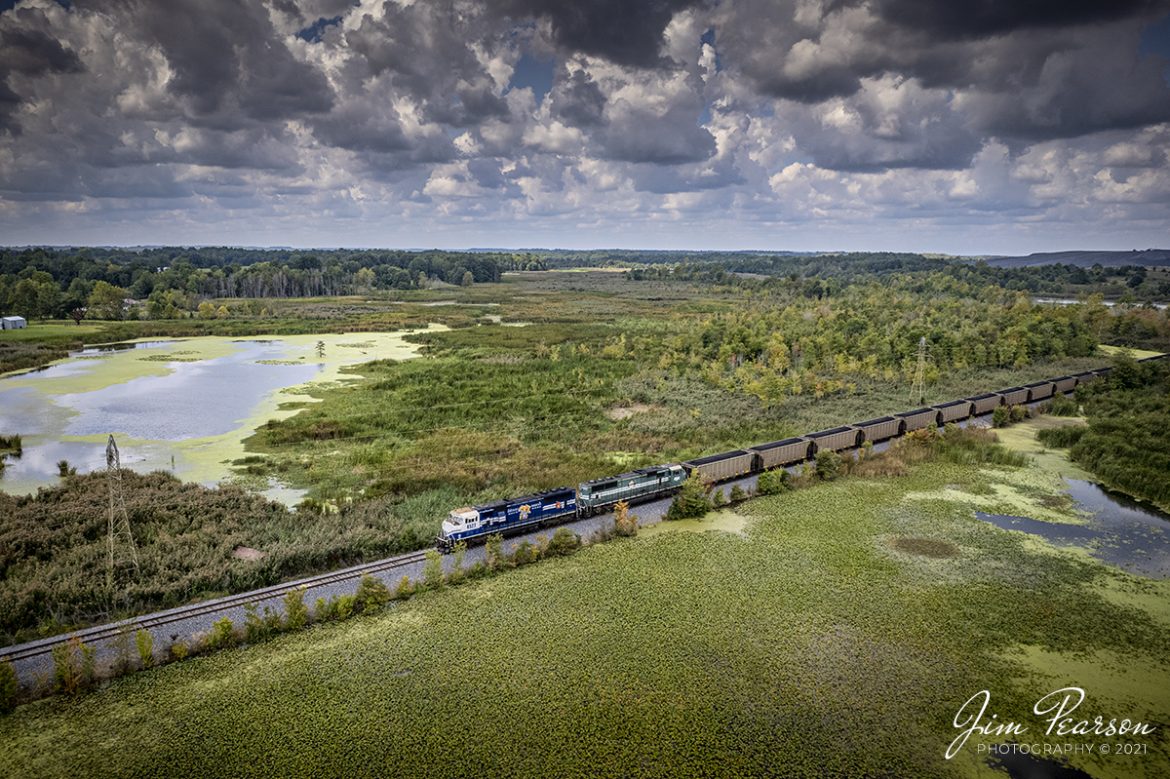 Paducah and Louisville Railway University of Kentucky Locomotive 4522 and PAL 4504 lead a northbound loaded Louisville Gas and Electric Coal train through a wetlands area as they depart on the Warrior Coal Mine lead, just west of Madisonville, Kentucky, on their way north to Louisville.

Tech Info: DJI Mavic Air 2S Drone, RAW, 22mm, f/2.8, 1/2000, ISO 100, September 13, 2021.

#trainphotography #railroadphotography #trains #railways #dronephotography #trainphotographer #railroadphotographer #jimpearsonphotography
