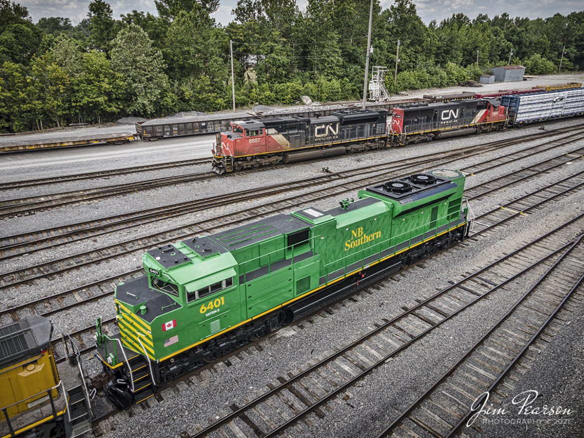The daily Canadian National Fulton to Paducah (FUPD) local, led by CN 8887 and 5485 passes newly refurbished NB Southern 6401 at the north end of the Paducah and Louisville Railway yard at Paducah, KY on June 29th, 2021, to do its interchange work.

Locomotive 6401 was the first of six units that are being refurbished by Progress Rail for NBSR out of Saint John, NB, Canada. The other units are 6402-6406 and they are all SD70M-2 units. 

According to Wikipedia: The New Brunswick Southern Railway Company Limited (reporting mark NBSR) is a 131.7 mi (212.0 km) Canadian short line railway owned by the New Brunswick Railway Company Limited, a holding company that is part of "Irving Transportation Services", a division within the industrial conglomerate J.D. Irving Limited.

#trainphotography #railroadphotography #trains #railways #dronephotography #jimpearsonphotography 

Tech Info: DJI Mavic Air 2 Drone, RAW, 4.5mm (24mm equivalent lens) f/2.8, 1/400, ISO 100.