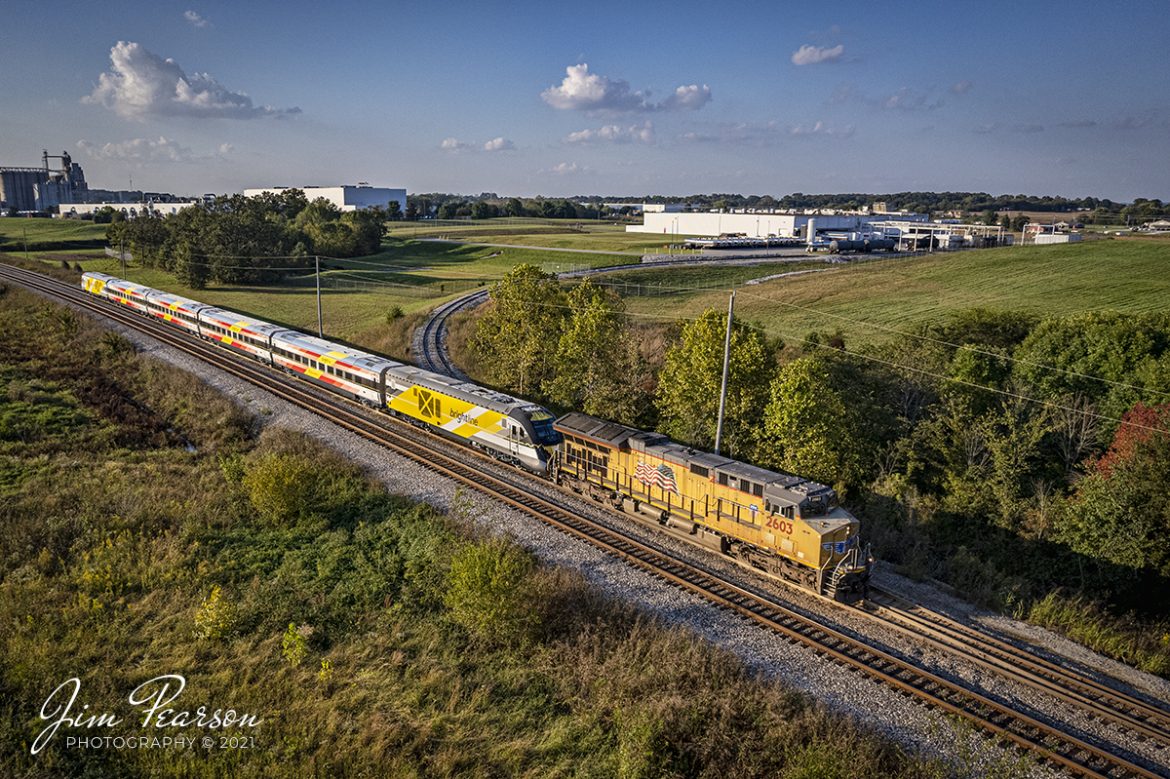 Union Pacific 2603 leads a brand new Brightline Commuter Trainset as it heads south as CSX W989 on the Henderson Subdivision at CSX Casky yard in Hopkinsville, Kentucky on its way south to Florida on October 8th, 2021.

According to Wikipedia: "Brightline is a privately run inter-city rail route between Miami and West Palm Beach, Florida. Brightline began operating over its current route in January 2018 and the company is currently building an extension to the Orlando International Airport which is expected to enter service in 2022.

As of August 2020, it is the only privately owned and operated intercity passenger railroad in the United States. The line was developed starting in March 2012 as All Aboard Florida by Florida East Coast Industries, a Florida real estate developer owned by Fortress Investment Group. Construction began in November 2014 on stations and improvements to tracks owned by the Florida East Coast Railway, which at the start of construction, was also owned by Fortress (it was sold in January 2018).

In late 2018, it was announced that Virgin Group would become a minority investor in the railroad and would provide rights to rebrand the service as Virgin Trains USA. In August 2020 they reverted to the Brightline name, ending the branding deal, claiming that Virgin had not provided the agreed investment money."

Tech Info: DJI Mavic Air 2S Drone, RAW, 22mm, f/2.8, 1/2000, ISO 100.

#trainphotography #railroadphotography #trains #railways #dronephotography #trainphotographer #railroadphotographer #jimpearsonphotography