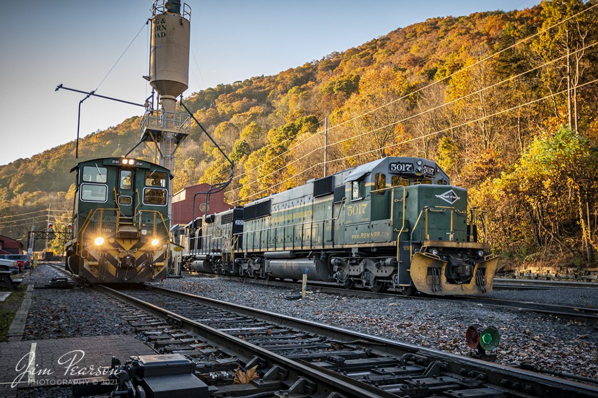 Reading Northern Blue Mountain Railroad switcher 1546 passes the sand tower as it works the yard at Port Clinton, Pennsylvania on a beautiful fall morning on November 5th, 2021

According to Wikipedia: The Reading Blue Mountain and Northern Railroad (reporting mark RBMN), sometimes shortened to Reading and Northern Railroad, is a regional railroad in eastern Pennsylvania. Its headquarters is in Port Clinton. The RBMN provides freight service on 300 miles (480 km) of track. Its mainline consists of the Reading Division between Reading and Packerton and the Lehigh Division between Lehighton and Dupont. Its main freight cargo is anthracite coal.

Passenger excursions also run on RBMN tracks. The RBMN itself operates excursion service from Reading and Port Clinton to Jim Thorpe, while the Lehigh Gorge Scenic Railway (LGSR) offers service between Jim Thorpe and Lehigh Gorge State Park.

According to their website: Locomotive 1546 is an EMD SW-1500, built in Feb 1970 and is ex CR 1606; Indianapolis Union Rwy 28; nee EMD demo 112. It is passing engine 5017, an EMD SD50, built in November of 1984 and is ex UP 5017; nee MP 5017.

Tech Info: Nikon D800, RAW, Nikon 10-20 @19mm, f/4.2, 1/320, ISO 400.

#trainphotography #railroadphotography #trains #railways #jimpearsonphotography #trainphotographer #railroadphotographer