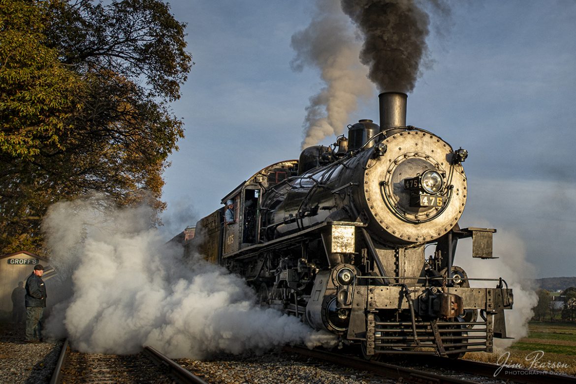 The late afternoon light lights the nose and steam of Norfolk and Western 475 as the engineer keeps a watchful eye on the road ahead, as he pulls his train forward in the siding at Groffs, during a Historic Transport Preservation, Inc, Steam Special from Strasburg, Pennsylvania on November 7th, 2021, to await the arrival of on an eastbound afternoon passenger train.

According to Wikipedia: Strasburg Railroad (Norfolk and Western) No. 475 is a 4-8-0 "Mastodon" type steam locomotive owned and operated by the Strasburg Railroad outside of Strasburg, Pennsylvania. Built by the Baldwin Locomotive Works in June 1906, it was part of the Norfolk and Western's first order of M class numbered 375-499. Today, No. 475 is the only operating 4-8-0 type in North America and the Strasburg Rail Road's oldest operating steam locomotive.

Tech Info: Nikon D800, RAW, Sigma 24-70 @ 24mm, f/4.5, 1/800, ISO 320.

#trainphotography #railroadphotography #trains #railways #jimpearsonphotography #trainphotographer #railroadphotographer