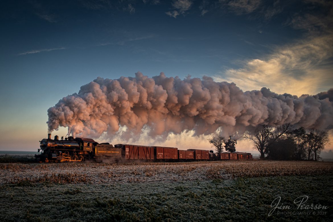 Norfolk and Western 475 heads west on the Strasburg Railroad as the glow of the rising sun illuminates the train and steam as the cold November air produces a spectacular show of steam trailing over the train, off into the distance, as the train approaches the Esbenshade Road Crossing on September 9th, 2021 at Strasburg, Pennsylvania. 

This is the first of many photos from my week-long road trip with fellow photographer Ryan Scott of Steelrails here on Facebook. We covered a total of over 2,300 miles, railfanning through the states of Kentucky, Indiana, Ohio, West Virginia, and Pennsylvania on the way to participate in the Historic Transport Preservation, Inc, Steam Special where we met up with fellow friend Bryan Burton.

It was a long, but outstanding railfan trip and we want to give a special shoutout to, Ethan Brodie, Albert Acker, Ryan Bruno, Ben Sutton, and others along the way that helped us during our trip with information and locations to shoot! With out your help and that of others we couldnt have done this trip as successfully! 

Tech Info: Nikon D800, RAW, Sigma 24-70 @ 24mm, f/2.8, 1/400, ISO 220.

#trainphotography #railroadphotography #trains #railways #jimpearsonphotography #trainphotographer #railroadphotographer