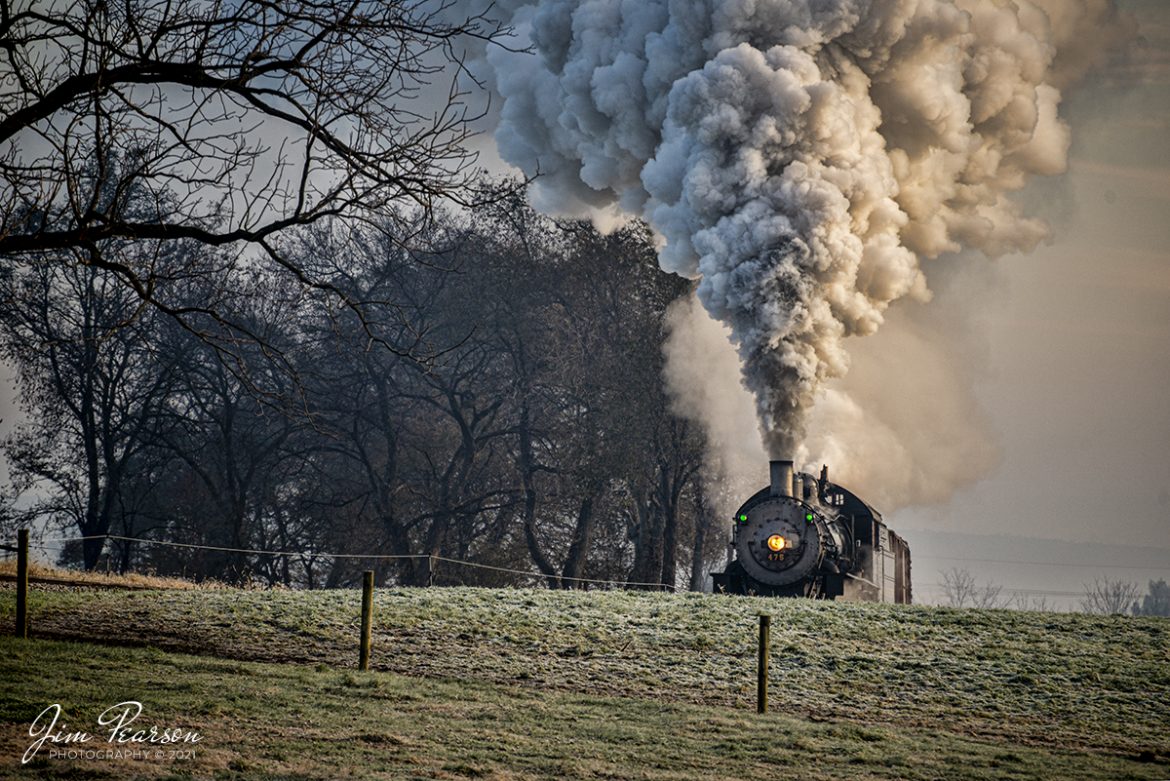 Norfolk and Western 475 peeks over the hill as it climbs the grade headed westbound up the long curve coming out of Leaman Place Junction at Paradise, PA, on the Strasburg Railroad as they head toward Strasburg, PA, on November 7th, 2021 in the early morning light. 

According to Wikipedia: Strasburg Railroad (Norfolk and Western) No. 475 is a 4-8-0 "Mastodon" type steam locomotive owned and operated by the Strasburg Railroad outside of Strasburg, Pennsylvania. Built by the Baldwin Locomotive Works in June 1906, it was part of the Norfolk and Western's first order of M class numbered 375-499. Today, No. 475 is the only operating 4-8-0 type in North America and the Strasburg Rail Road's oldest operating steam locomotive.

Tech Info: Nikon D800, RAW, Sigma 150-600 @ 300mm, f/5.6, 1/320, ISO 400.