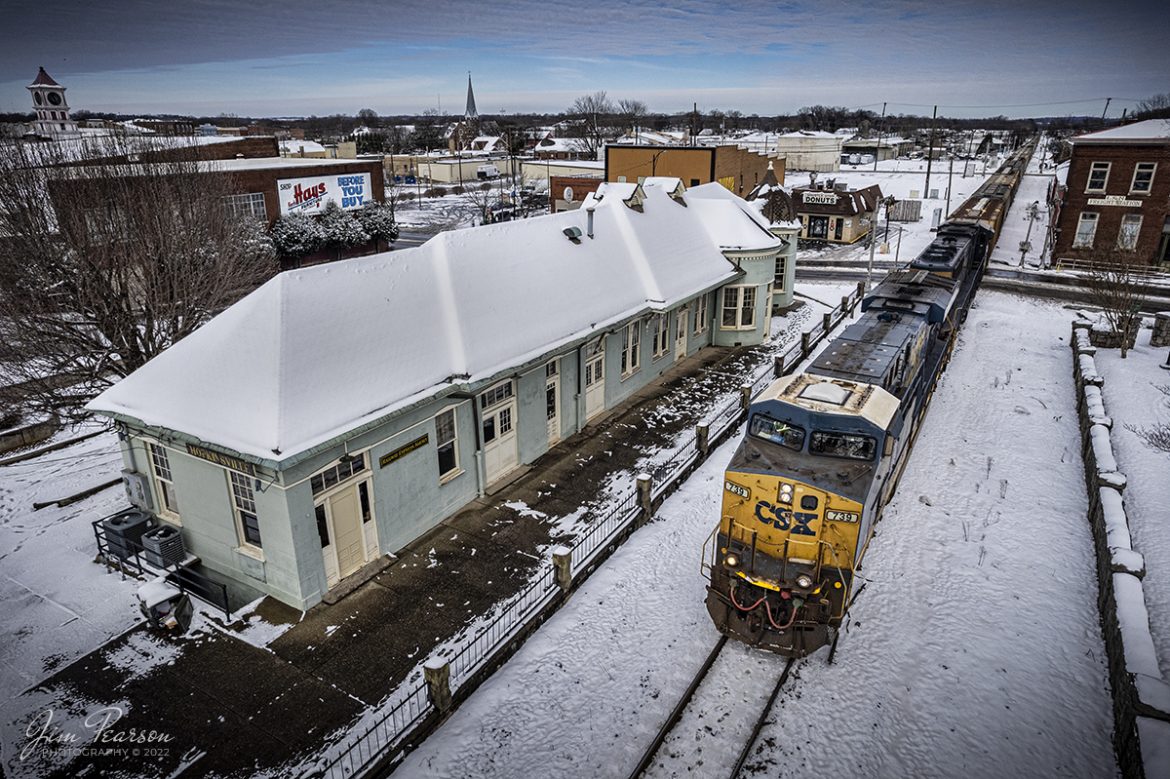 CSXT 739 leads loaded grain train G419 past the old Louisville and Nashville (L&N) Railroad Depot after our first snowfall of the year on the Henderson Subdivision on January 7th, 2022. The snow which began to fall on the 6th brought a total of 4-6 inches of snow to the region and caused delays on the railroad due to switch problems along the line due to the snow and cold.

According to Wikipedia: The L &N Railroad Depot in the Hopkinsville Commercial Historic District of Hopkinsville, Kentucky is a historic railroad station on the National Register of Historic Places. It was built by the Louisville & Nashville Railroad in 1892.

The year 1832 saw the first of many attempts to woo a railroad to Hopkinsville. This first attempt was to connect Hopkinsville to Eddyville, Kentucky. In 1868 Hopkinsville finally obtained a railroad station, operated by the Evansville, Henderson, & Nashville Railroad. The Louisville & Nashville Railroad acquired the railroad in 1879.

The Hopkinsville depot is a single-story frame building with a slate roof. It has six rooms: A Ladies Waiting room (the room closest to the street), a General Waiting Room, a Colored Waiting Room, a baggage room (the furthest room from the street), a ticket office (the only room which connected to all three waiting rooms), and a ladies' restroom. Immediately outsides were warehouses for freight, usually tobacco.

Its last long-distance (passenger) train was the Louisville and Nashville's Georgian, last operating in 1968.

During its operating years, the Hopkinsville depot was a popular layover spot for those traveling by train. It was the only Louisville & Nashville station between Evansville, Indiana and Nashville, Tennessee where it was legal to drink alcohol. Hopkinsville got the nickname Hop town due to train passengers asking the conductors when they would arrive at Hopkinsville, so they could "hop off and get a drink".

The Hopkinsville L&N Railroad Depot was placed on the National Register of Historic Places on August 1, 1975. CSX, which bought out the Louisville & Nashville, still run trains on the tracks next to the depot, but do not stop."

Tech Info: DJI Mavic Air 2S Drone, RAW, 22mm, f/2.8, 1/3200, ISO 110.

#trainphotography #railroadphotography #trains #railways #jimpearsonphotography #trainphotographer #railroadphotographer