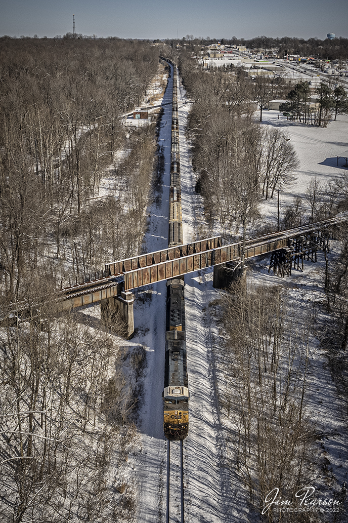 CSX G419, a loaded grain train, passes under the Paducah and Louisville Railway, on a 11-degree snowy winters day, as it heads south at the location known as Monarch on the Henderson Subdivision at Madisonville, Kentucky on January 7th, 2022.

Tech Info: DJI Mavic Air 2S Drone, RAW, 22mm, f/2.8, 1/3000, ISO 130.

#trainphotography #railroadphotography #trains #railways #jimpearsonphotography #trainphotographer #railroadphotographer