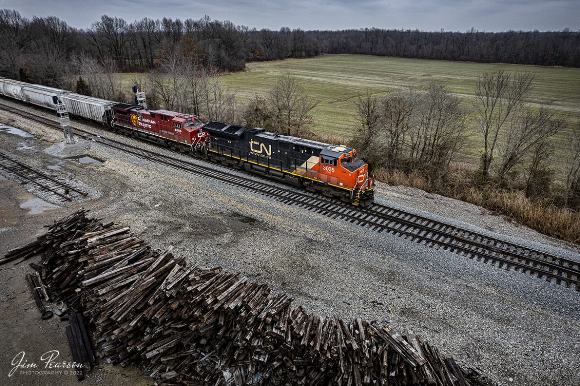 Canadian National 3035 and Canadian Pacific 8005 head south with a grain train as they pass a stack of old ties at the north end of Chiles Junction at West Paducah, Kentucky on the CN Bluford Subdivision. 

Fellow railfan Ryan Scott and I of SteelRails on Facebook, set out early yesterday morning on January 15th, 2022, and made our way up the Paducah and Louisville Railway line out of Madisonville, Ky in search of the snow front that was headed through the area. Well, all we found in our travels were flurries, but we did catch a variety of railroads during the trip which were CN, CP, BNSF and Progress Rail! All in all, a good trip!

Tech Info: DJI Mavic Air 2S Drone, RAW, 22mm, f/2.8, 1/500, ISO 200.

#trainphotography #railroadphotography #trains #railways #jimpearsonphotography #trainphotographer #railroadphotographer