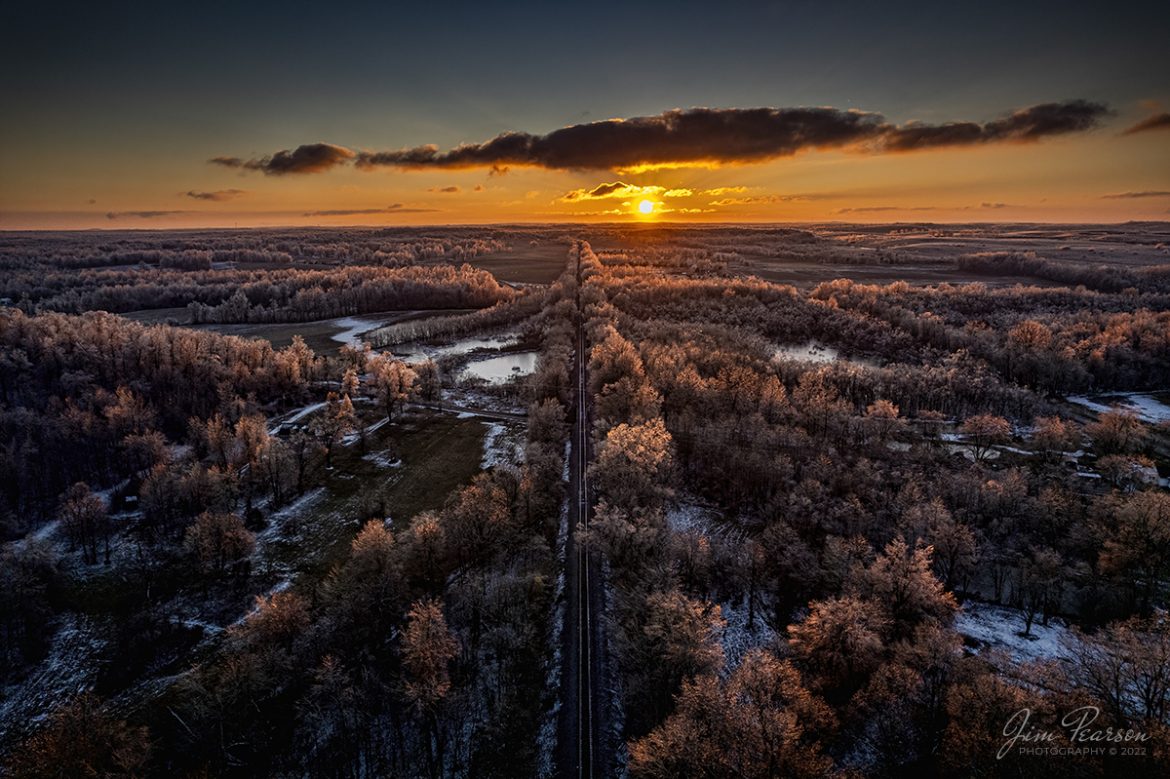 The sun sets over the Paducah and Louisville Railway as the sun rakes across the ice-covered trees at Richland, Ky on February 5th, 2022, in this ultrawide angle shot from my DJI Air 2S drone. 

The recent weather front that passed through the region left a spectacular display of ice in the trees for several days. Thankfully it didnt cause much disruption in my area, unlike the last ice storm through here that left me without power for 6 days in 2009!

Tech Info: DJI Mavic Air 2 Drone, RAW, 4.5mm (24mm equivalent lens) f/2.8, 1/1000, ISO 110, underexposed by 3 stops for the sun.

#trainphotography #railroadphotography #trains #railways #jimpearsonphotography #trainphotographer #railroadphotographer