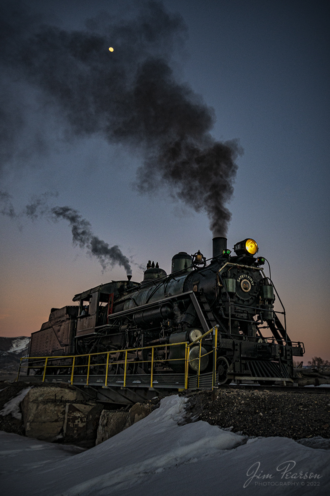 After dropping its ashes from a days work, Nevada Northern Railway steam locomotive #81 prepares to pull away from the ash pit as the light fades from the sky during the museums 2022 Winter Photo Charter event on February 12th, 2022, at Ely, Nevada. 

I was hoping to get the ash dump in the photo, but the crew did such a good job on firing today that there was only enough ashes for one drop and it of course happened when I wasnt ready! LOL. Sometimes it happens!

According to Wikipedia: The Nevada Northern Railway Museum is a railroad museum and heritage railroad located in Ely, Nevada and operated by a historic foundation dedicated to the preservation of the Nevada Northern Railway.

The museum is situated at the East Ely Yards, which are part of the Nevada Northern Railway. The site is listed on the United States National Register of Historic Places as the Nevada Northern Railway East Ely Yards and Shops and is also known as the "Nevada Northern Railway Complex". The rail yards were designated a National Historic Landmark District on September 27, 2006. The site was cited as one of the best-preserved early 20th-century railroad yards in the nation, and a key component in the growth of the region's copper mining industry. Developed in the first decade of the 20th century, it served passengers and freight until 1983, when the Kennecott Copper Company, its then-owner, donated the yard to a local non-profit for preservation. The property came complete with all the company records of the Nevada Northern from its inception.

Locomotive #81 is a "Consolidation" type (2-8-0) steam locomotive that was built for the Nevada Northern in 1917 by the Baldwin Locomotive Works in Philadelphia, PA, at a cost of $23,700. It was built for Mixed service to haul both freight and passenger trains on the Nevada Northern railway.

Tech Info: Nikon D800, RAW, Nikon 10-24 @ 18mm, f/5, 1/400, ISO 125, Exp. Comp.: -1.0.

#trainphotography #railroadphotography #trains #railways #jimpearsonphotography #trainphotographer #railroadphotographer #steamtrains #nevadanorthernrailway