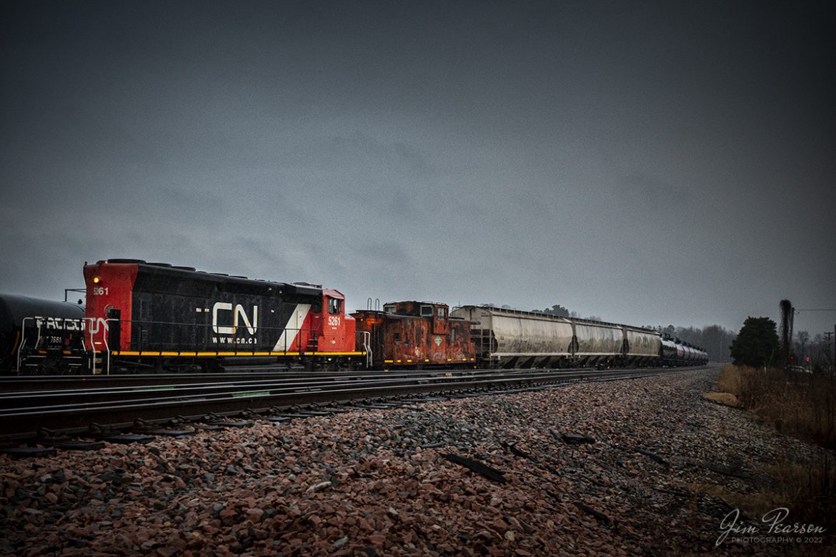The crew on Canadian National 5261, with Illinois Central Caboose 199060 which has seen much better days, works on a pickup at Mounds, Illinois on the CN Centralia Subdivision during a wet, gloomy evening on December 29th, 2021.

Tech Info: Nikon D800, RAW, Nikon 10-20mm @ 10mm, f/3.5, 1/200, ISO 1110.

#trainphotography #railroadphotography #trains #railways #jimpearsonphotography #trainphotographer #railroadphotographer