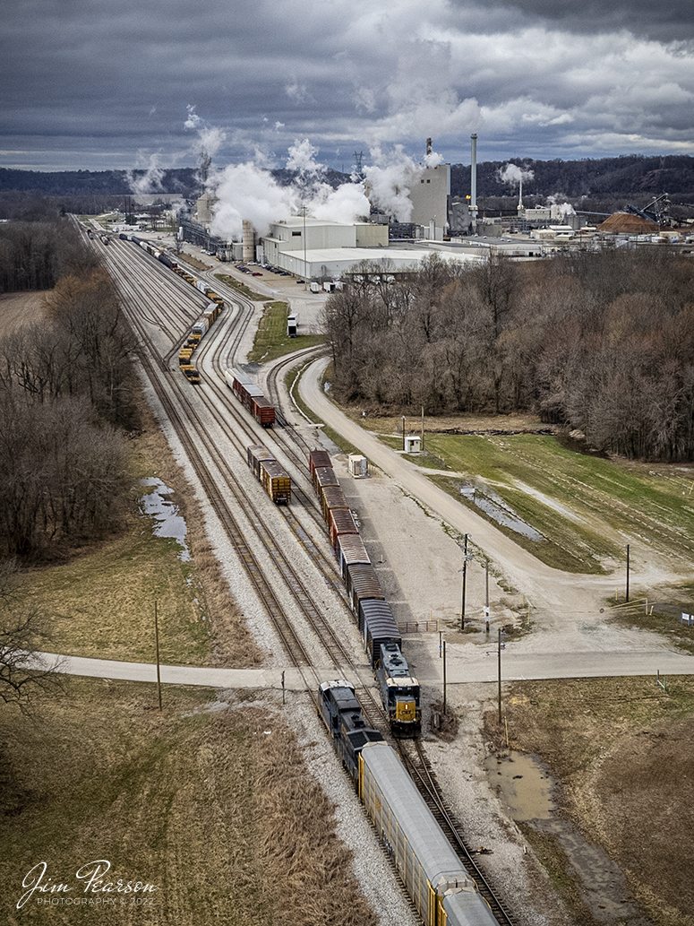 CSX 483 leads CSX Q228 meets a local working the Domtar Paper Company at Skillman, Kentucky at the CSX Skillman Yard on the CSX Texas Line (LH&StL Subdivision) as it as 228 heads west to the Toyota Plant in Princeton, Indiana from Louisville, KY on March 7th, 2022.

CSX currently runs two through trains daily along the line and it has been open now for about two weeks. It also sees several locals as well. While the bridge was shut down trains were pretty much just locals between Louisville and Henderson, Ky (where the Texas line runs).

According to Wikipedia: The LH&STL Subdivision is a railroad line owned by CSX Transportation in the U.S. state of Kentucky. It was originally built as the Louisville, Henderson, and Texas Railway in 1882, with the intent of building a line to Texas by way of St. Louis, Missouri. It was nicknamed "The Texas Line," by which it is still often referred today. The line fell into bankruptcy and was reorganized as the Louisville, Henderson, and St. Louis Railway in 1896. The rail line was acquired by the Louisville and Nashville Railroad in 1929; the parent company still exists and holds other rail-related assets. Through a series of mergers, the line is now operated by CSX.

The line runs from Louisville, Kentucky, to Henderson, Kentucky, for a total of 136.5 miles (219.7 km). At its east end the line continues west from the Louisville Terminal Subdivision, and at its west end the line continues west as the Henderson Subdivision of the Nashville Division.

Tech Info: DJI Mavic Air 2S Drone, RAW, 22mm, f/2.8, 1/1250, ISO 140.

#trainphotography #railroadphotography #trains #railways #dronephotography #trainphotographer #railroadphotographer #jimpearsonphotography
