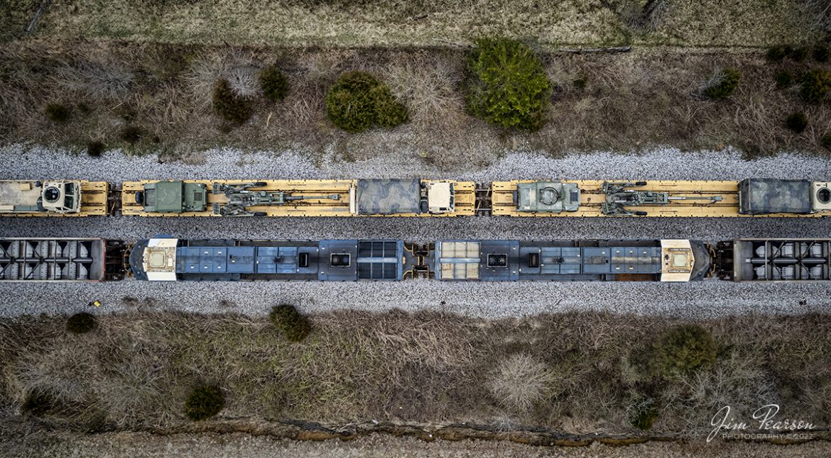 The unmanned CSX DPU's on a combined 12,000 ft empty coal train on E302 passes loaded military train S864 sitting in the siding at Kelly, Kentucky on the Henderson Subdivision on March 8th, 2022. 

According to the web: DPU - Stands for Distributed Power Unit, a locomotive set capable of remote-control operation in conjunction with locomotive units at the train's head end. DPUs are placed in the middle or at the rear of heavy trains (such as coal, grain, soda ash and even manifest) to help climb steep grades.

CSX S864 is a Rose Lake, IL - Hopkinsville, Ky train and was returning the military equipment to Ft. Campbell, Ky from training exercises in the west, where Ft. Campbell Rail picked the train up off the Ft. Campbell wye connection and took it onto the post.

Tech Info: DJI Mavic Air 2S Drone, RAW, 22mm, f/2.8, 1/500, ISO 100.

#trainphotography #railroadphotography #trains #railways #dronephotography #trainphotographer #railroadphotographer #jimpearsonphotography