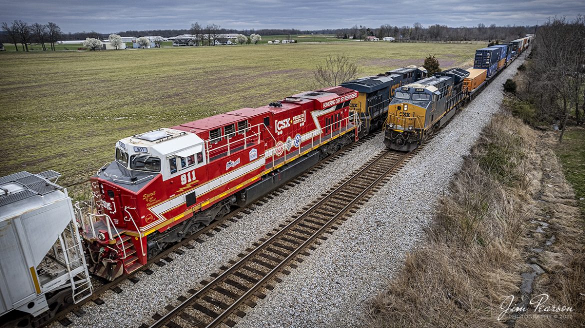 Northbound intermodal I026 meets southbound ethanol train B795 with the CSXT 911, Honoring First Responders trailing, at the south end of the siding at Crofton, Kentucky on the Henderson Subdivision on March 25th, 2022.

CSXT 911 is painted in vibrant red with white and gold striped accents along with the logo of program partners First Responders Childrens Foundation and Operation Gratitude. It also features generic police, fire and emergency medical services logos.

Tech Info: DJI Mavic Air 2S Drone, RAW, 22mm, f/2.8, 1/1000, ISO 110

#trainphotography #railroadphotography #trains #railways #dronephotography #trainphotographer #railroadphotographer #jimpearsonphotography