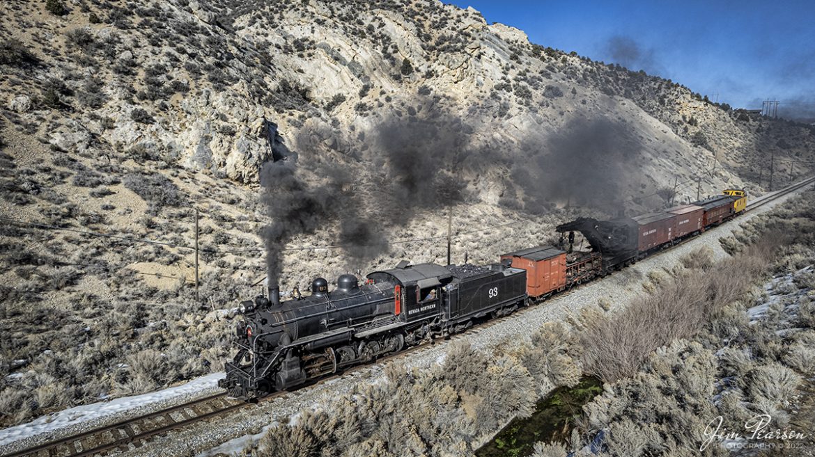 Nevada Northern Railway steam locomotive #93 pulls a wreck train southbound through Robinson Canyon after departing Ely, Nevada on the final day of their 3-day Winter Photography Charter on February 13th, 2022.

According to Wikipedia: The Nevada Northern Railway Museum is a railroad museum and heritage railroad located in Ely, Nevada and operated by a historic foundation dedicated to the preservation of the Nevada Northern Railway.

The museum is situated at the East Ely Yards, which are part of the Nevada Northern Railway. The site is listed on the United States National Register of Historic Places as the Nevada Northern Railway East Ely Yards and Shops and is also known as the "Nevada Northern Railway Complex". The rail yards were designated a National Historic Landmark District on September 27, 2006. The site was cited as one of the best-preserved early 20th-century railroad yards in the nation, and a key component in the growth of the region's copper mining industry. Developed in the first decade of the 20th century, it served passengers and freight until 1983, when the Kennecott Copper Company, its then-owner, donated the yard to a local non-profit for preservation. The property came complete with all the company records of the Nevada Northern from its inception.

Locomotive #93 is a 2-8-0 that was built by the American Locomotive Company in January of 1909 at a cost of $17,610. It was the last steam locomotive to retire from original revenue service on the Nevada Northern Railway in 1961 and was restored to service in 1993.

Tech Info: DJI Mavic Air 2 Drone, RAW, 4.5mm (24mm equivalent lens) f/2.8, 1/1600, ISO 100.

#trainphotography #railroadphotography #trains #railways #jimpearsonphotography #trainphotographer #railroadphotographer #nevadanorthernrailway #steamtrain