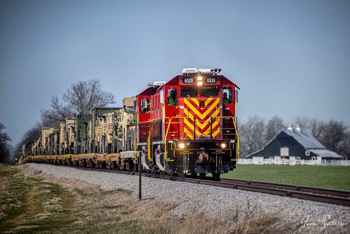 On March 14th, 2022, United States Army Gensets 6519 and 6520 head south as they approach the Locus Grove Road crossing at Hopkinsville, Kentucky with another loaded military train, returning from military exercises somewhere out west.  

The equipment was delivered by CSX S864, which was a Rose Lake, IL  Hopkinsville, Ky train and was one of about 5 trains that ran down the CSX CE&D and Henderson Subdivisions to Hopkinsville over the past week, returning equipment from training to Ft. Campbell.

Tech Info: Nikon D800, RAW, Sigma 150-600 @ 360mm, f/5.6, 1/400, ISO 100.

#trainphotography #railroadphotography #trains #railways #jimpearsonphotography #trainphotographer #railroadphotographer