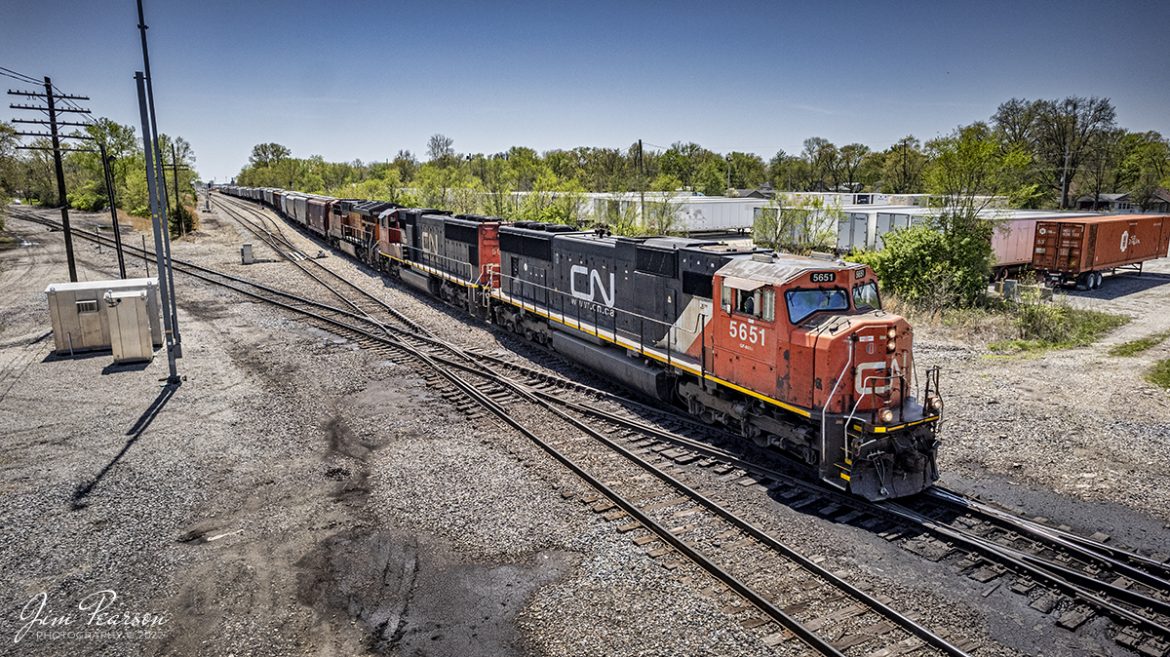Canadian National 5651 leads a empty grain train out of the CN yard at Centralia, Illinois as it heads north on the Centralia Subdivision on April 27th, 2022, with another CN and BNSF unit trailing, as they pass over the ICG Crossing.

Centralia is named for the Illinois Central Railroad, which was built in 1853. The city was founded at the location where the two original branches of the railroad converged and today the line is owned by the Canadian National, although BNSF and Norfolk Southern also have a presence here now. 

Tech Info: DJI Mavic Air 2S Drone, RAW, 22mm, f/2.8, 1/2500, ISO 150.

#trainphotography #railroadphotography #trains #railways #dronephotography #trainphotographer #railroadphotographer #jimpearsonphotography